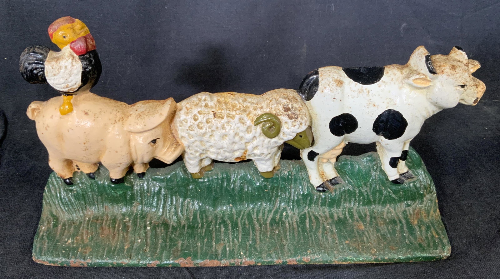 Vintage Cast Iron Farm Animal Doorstop: Vintage Cast Iron Farm Animal Doorstop, possibly antique, no apparent inscriptions or marks, subject a cow, ram, pig, and rooster in a row, measures 5 1/2 x 11 inches, some rusting and losses to pigme