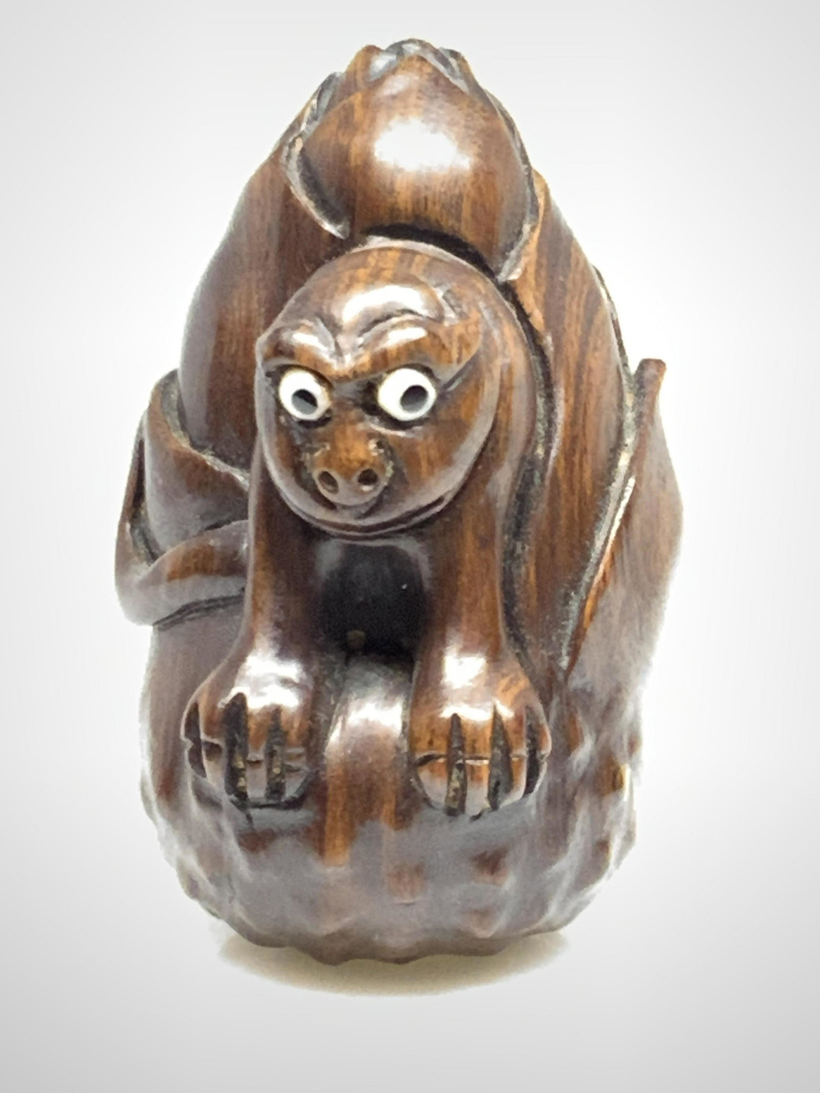 Antq SIGNED Asian Wooden MONKEY & BAMBOO NETSUKE: Antique dark brown wooden netsuke of a monkey coming out of the center of a bamboo shoot. This is a kataborinetsuke, a sculptural netsuke. The netsuke stands on it’s own and features carved details 