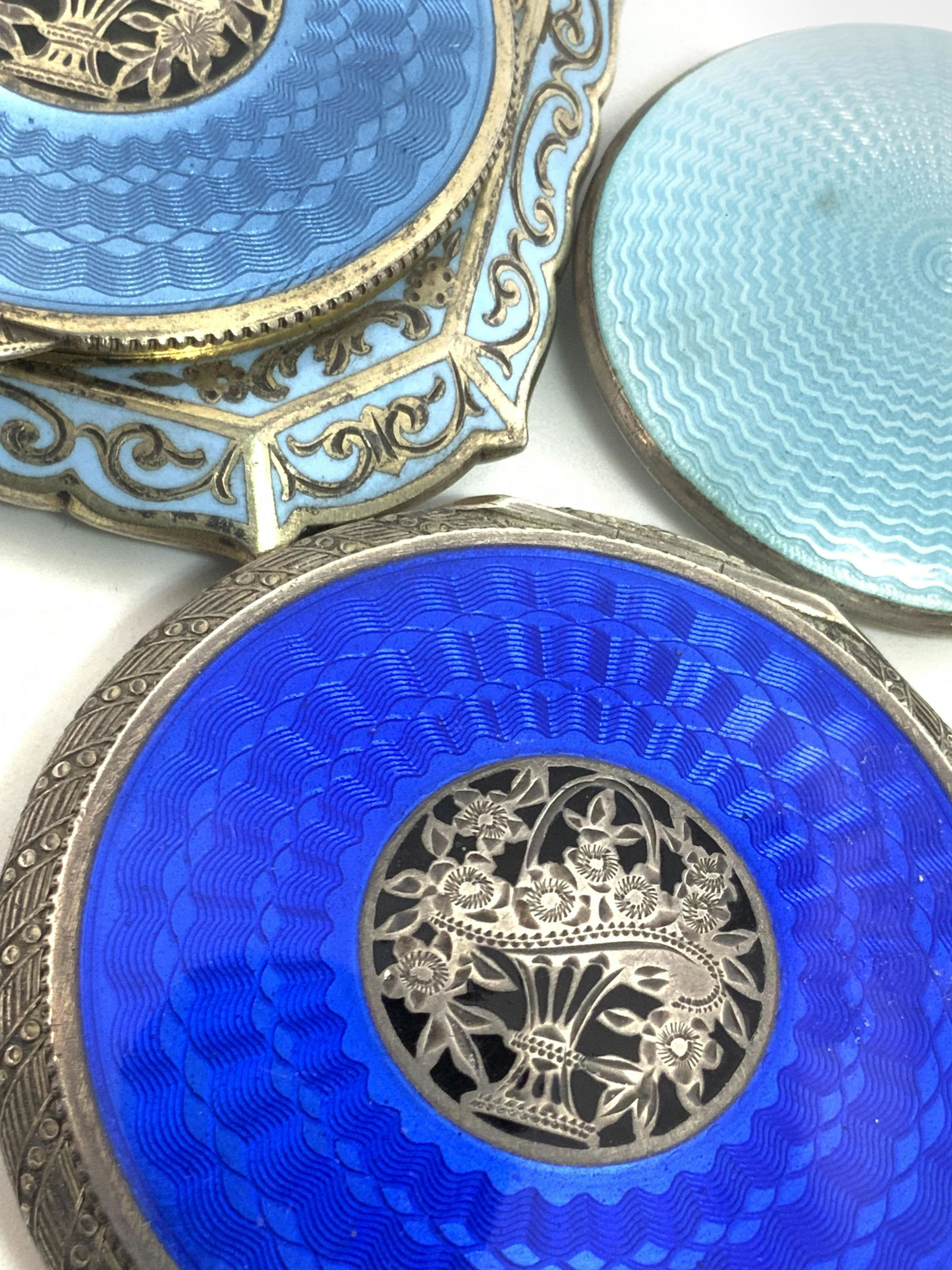 Lot3 Signed Sterling GUILLOCHE Pill Boxes, Austria: Three guilloche pill boxes / compacts. Antique and vintage. All pieces have hinge hardware. Two pieces are are crafted in Austria. Both have a center design depicting a basket overflowing with flowers