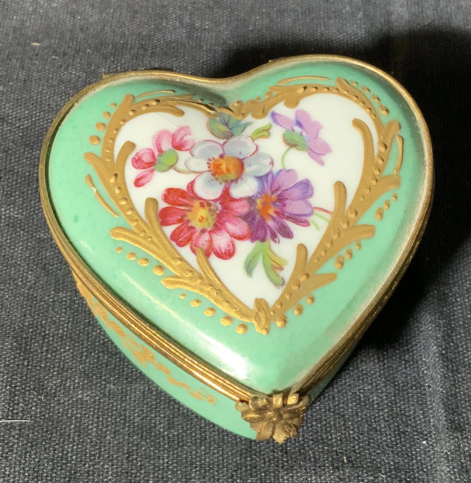 Antique Early LIMOGES French Porcelain Pill Box: Antique Early Limoges French porcelain hinged box, understand stamped with trademark, writing to underside reads ‘Limoges France’, exterior painted green and white with floral designs, gold metal 