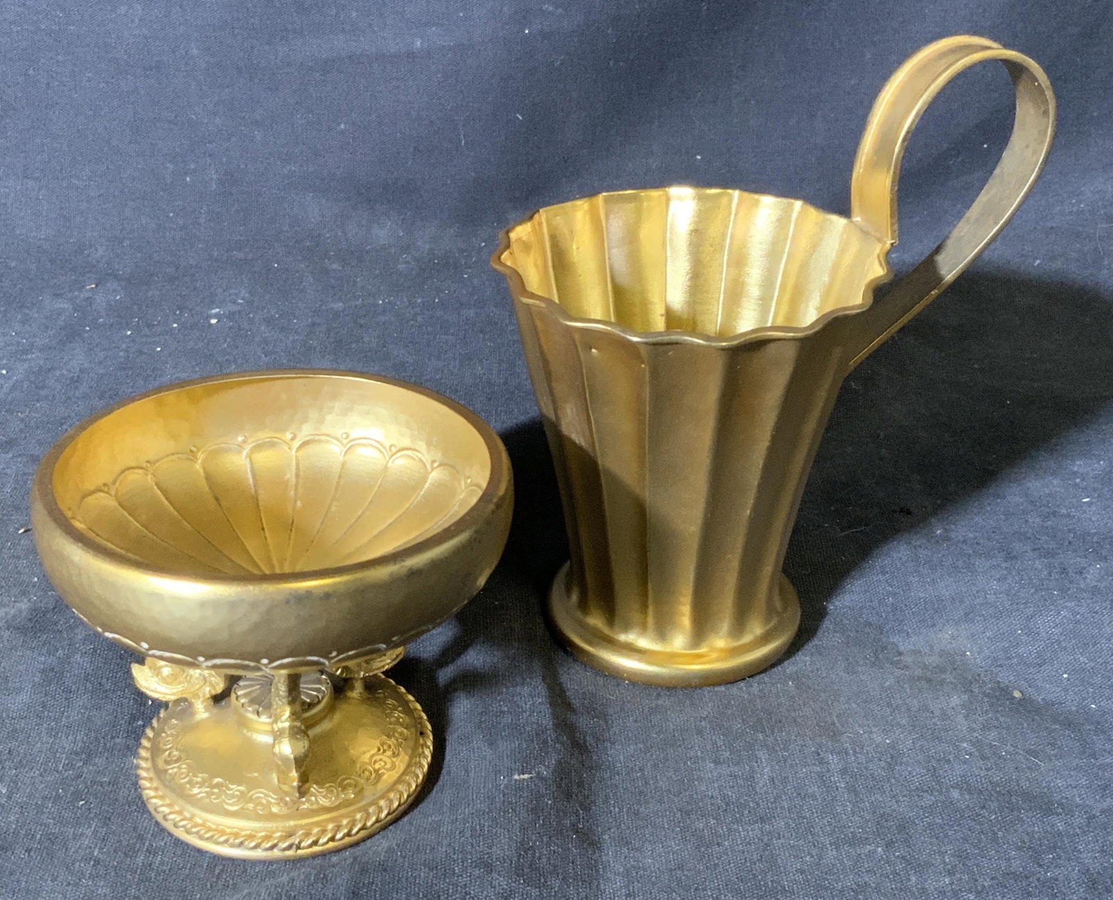 Gold Plated Silver Pedestal Bowl and Cup: Gold toned plate, possibly gold plated over silver. pedestal bowl and cup, both are marked to their underside in another language, bowl’s pedestal is made of three upside down dolphin figures, bowl 