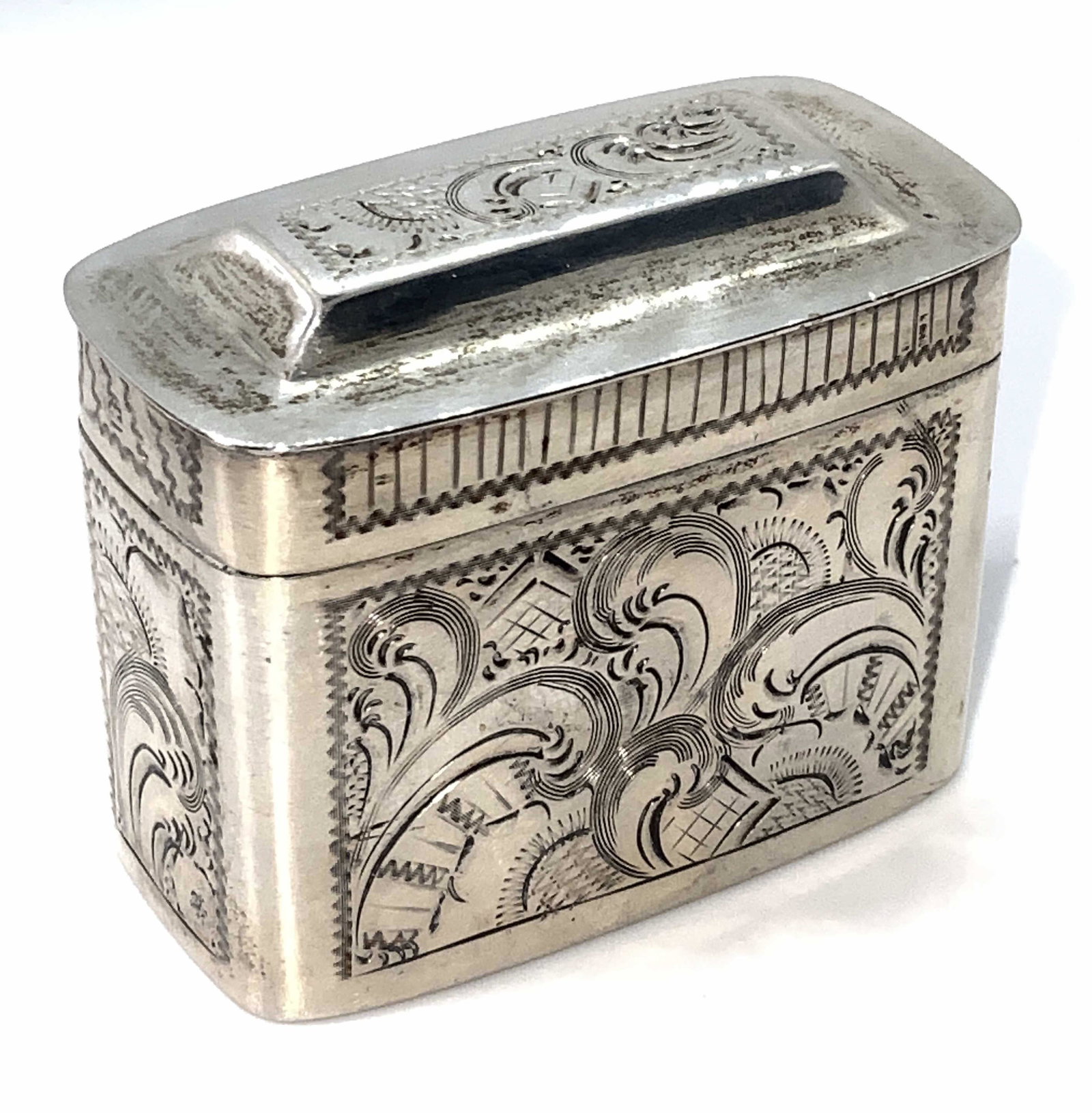 Antique Dutch Hallmarked Sterling Silver Pill Box: An antique (circa 1857) Dutch sterling silver pill box. This piece has hinge hardware that connects the base to the lid. The exterior detailing features intricately etched designs. Hallmarks are visib