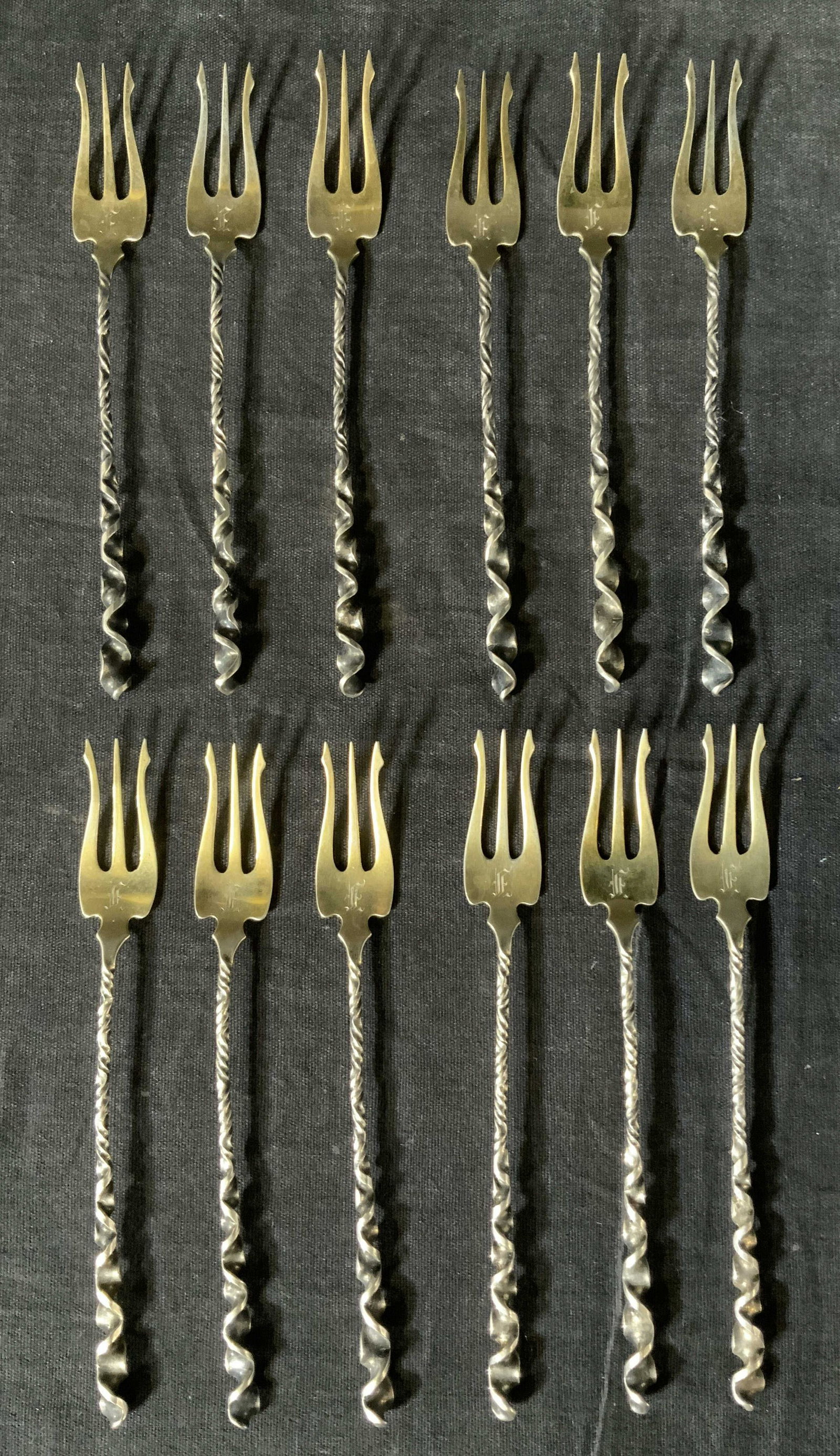 Set 12 Antique Sterling Silverhors d'oeuvres Forks: Set 12 Marked Antique Sterling Silver with gold wash Pickle Forks, inscription reads ‘10 Sterling W 8’, all measure 5 3/8 inches long, total weight: 4,16 ozt, some surface wear and tarnishing to p