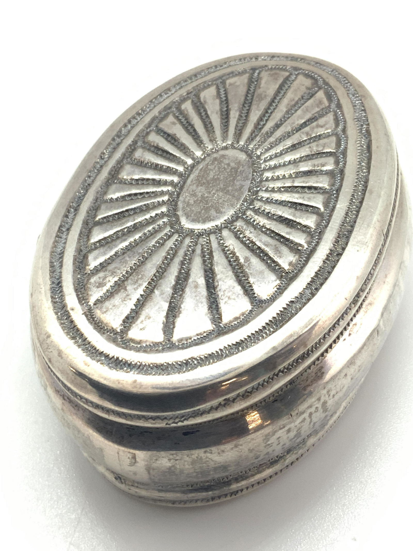 Antique Sterling Silver Spice Grater: An antique sterling silver spice grater. This piece features detailed and and embossed metalwork along all surfaces, top & underside. Sides are polished. Hinge hardware. The piece opens to reveal a gr