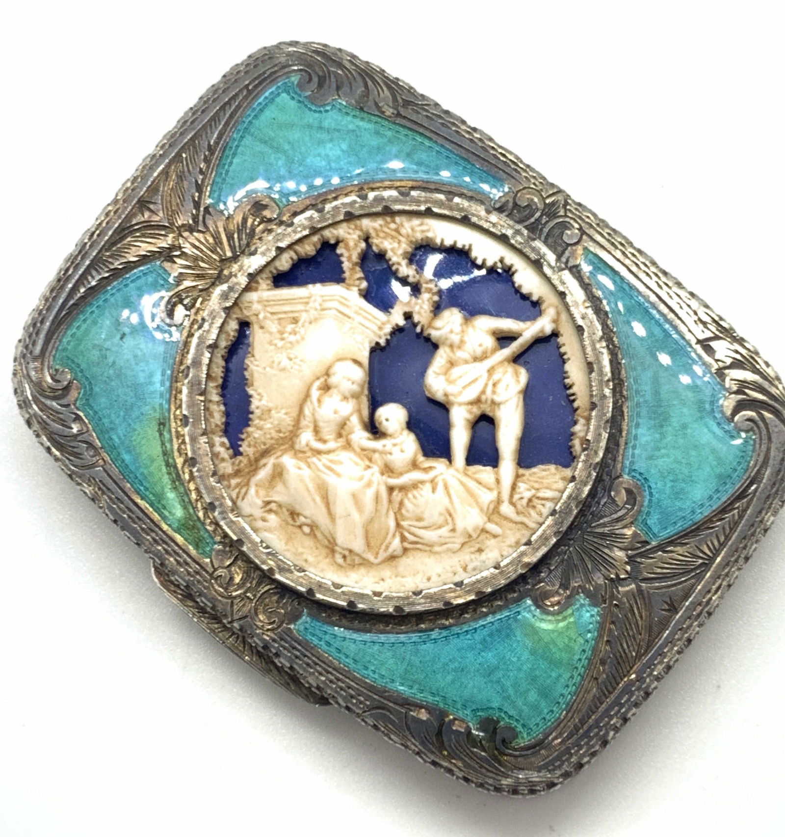 Vntg Handmade Silver & Enamel Mirrored Compact: A vintage, possibly antique, silver enameled mirrored compact. Precise hand carved and etched silver & enamel work all throughput. The center scene is possibly carved bone. The scene depicts two women