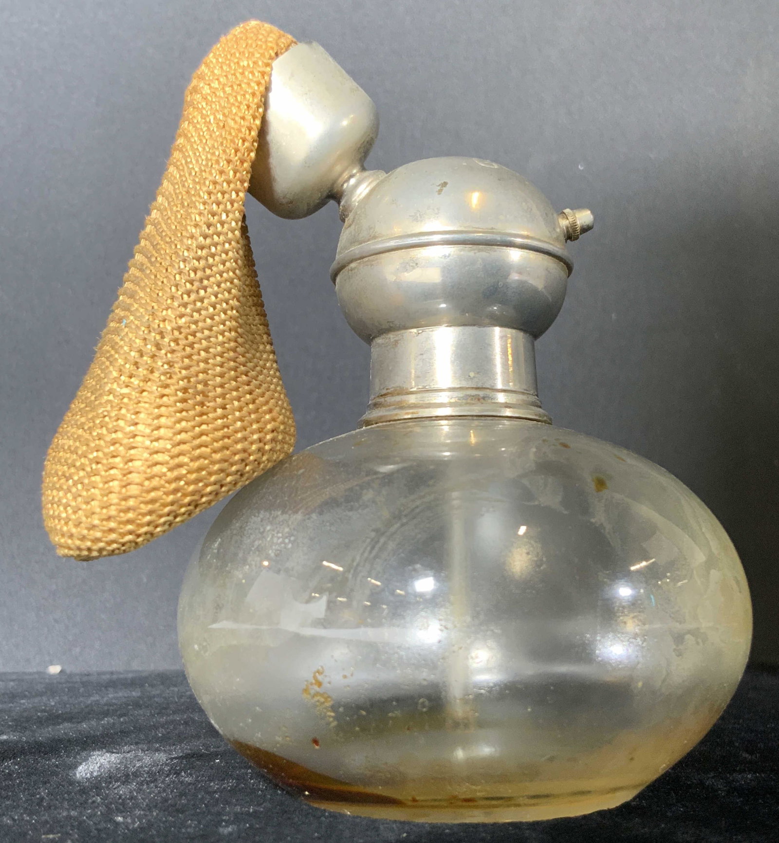 GUERLAIN Signed Vintage Atomizer Perfume Bottle: A rare vintage, possibly antique, atomizer perfume bottle created by Guerlain. The piece is crafted from colorless, clear glass formed into an orb. The top is a silver tone metal signed in block lette