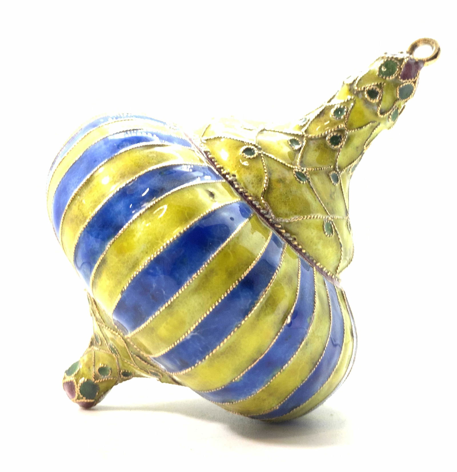 Hand Painted Enamel Hanging Ornament, Boxed: A hand painted, enameled metal ornament. In the form of a pointed spinning top. Primarily blue and yellow tones surf green & purple accents. Decorative gold tone banding breaks up the repeating blue &