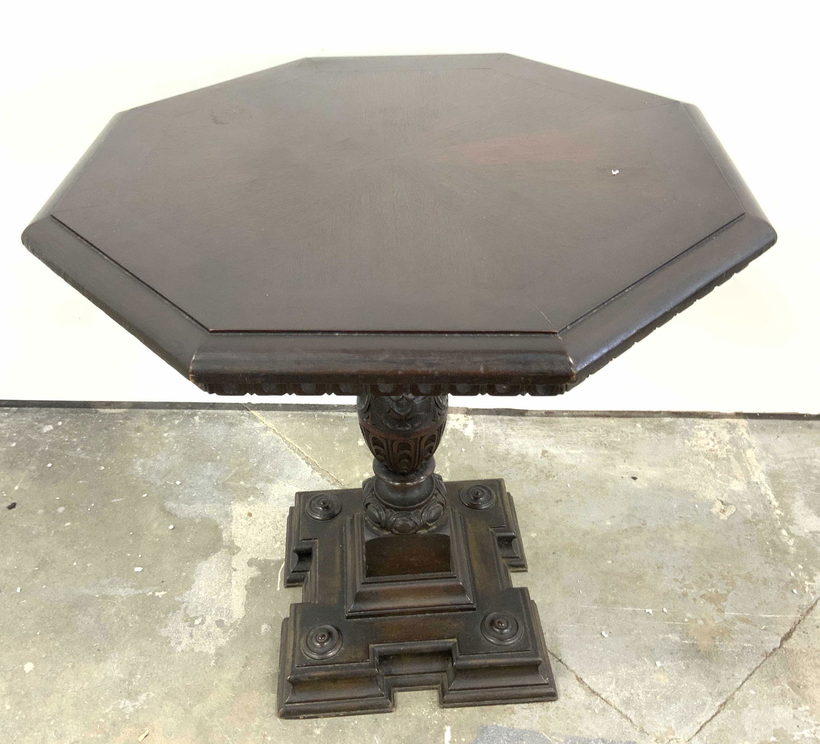 Antq Carved Wooden Octagonal Pedestal Side Table: Side table is vintage possibly antique. Rich brown hues. Tabletop has octagonal shape. Table is pedestaled. Contains intricately carved pedestal and base. Piece measures approx 24 inches tall 23 inche