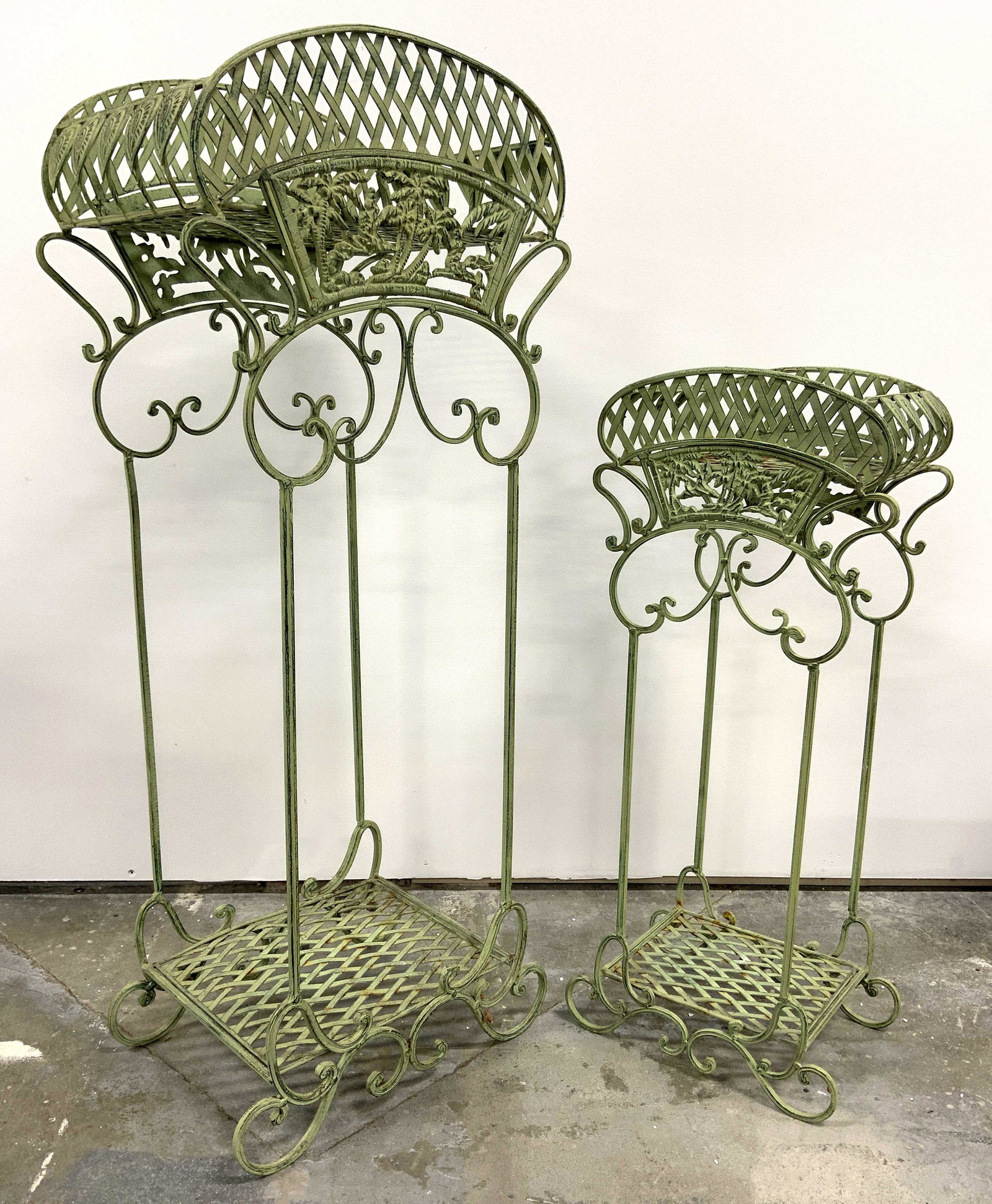 Lot 2 Vintage Metal Woven Plant Stands: Plant stands are vintage possibly antique. Each piece is green toned and metal. Each have c curve structures, palm tree structures, in addition to diamond shaped pattern structures on top. Largest sta