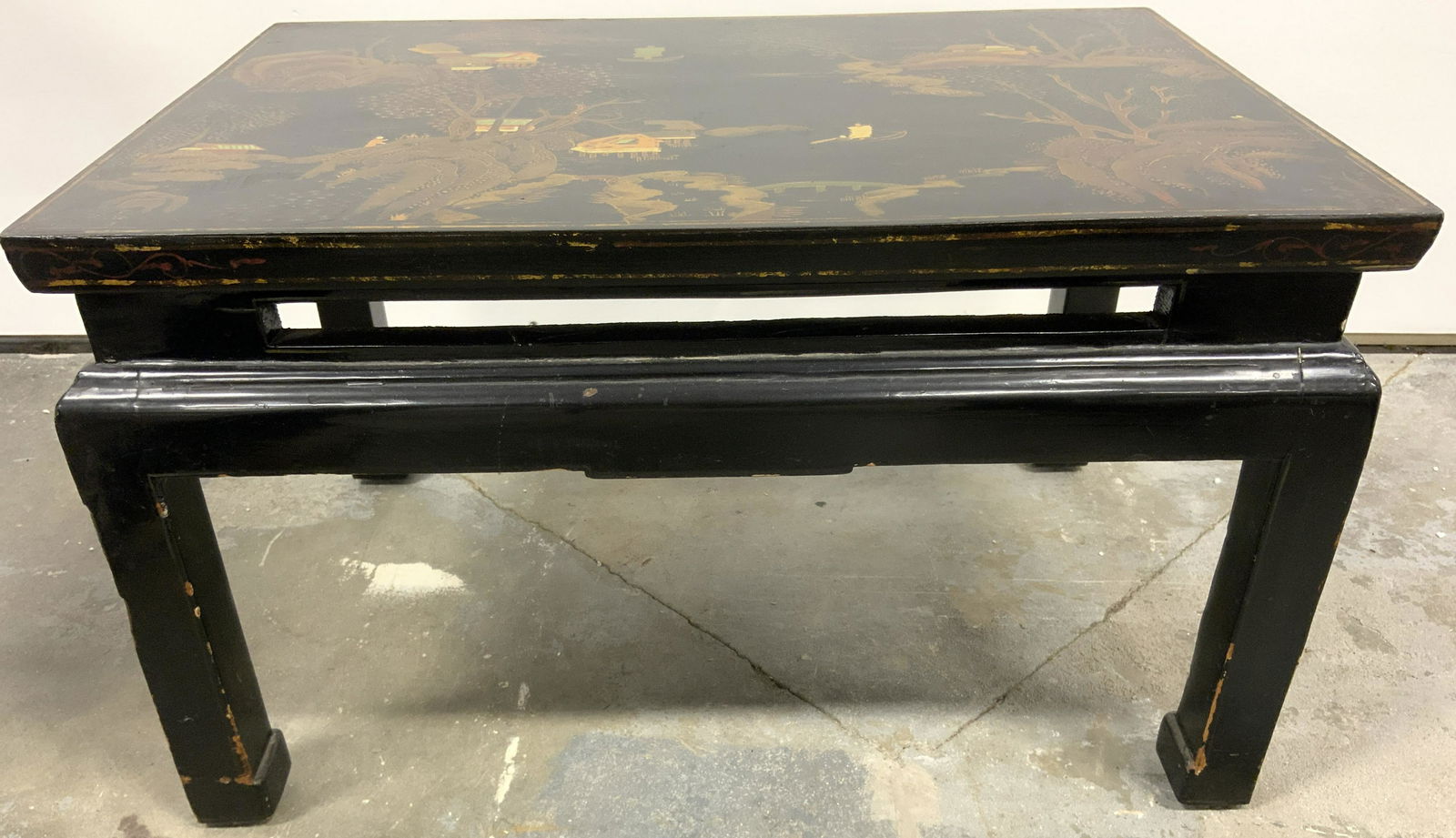 Vintage Lacquered Asian Coffee Table: Coffee table is vintage possibly antique. Piece is black toned and lacquered. Piece has painted tree & leaf detail. Piece has black bas toned with painted detail. Piece appears to possibly be hand pai
