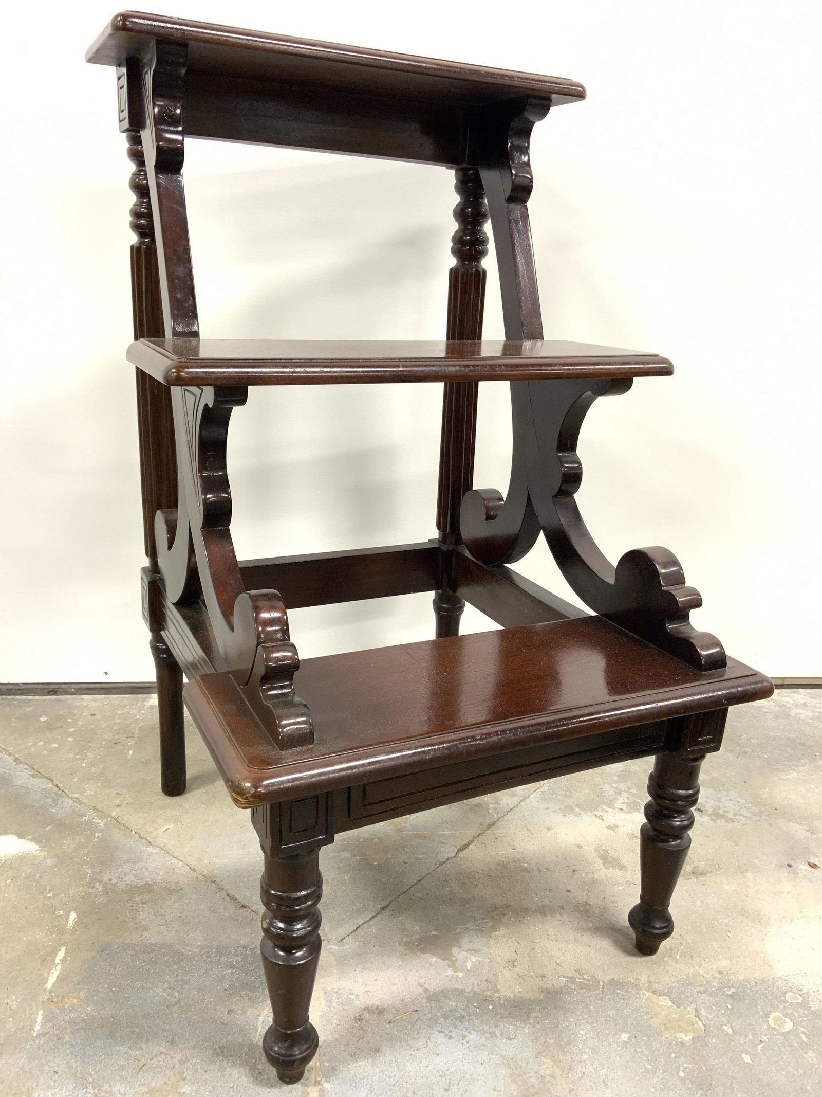 Vintage Carved Wooden Step Stool: Step stool appears to be vintage. Piece is wooden possibly mahogany. Contains 2 steps. Piece has 4 carved wooden feet and other carved areas. Piece measures approx 32 inches tall and deep 16.5 inches 