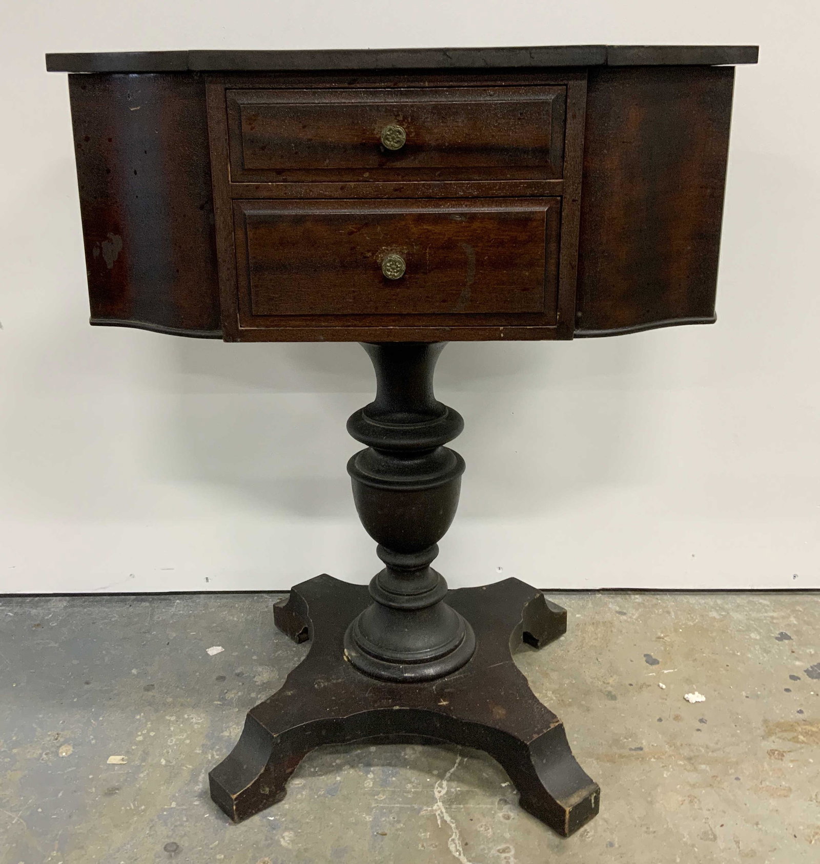Antique Wooden Pedestal Based Nightstand: Antique wooden nightstand, two drawers, each with a metal drawer pull, and two storage compartment, one on each side. Hinged kids open to reveal compartments. Table is supported by a pedestal, pedesta