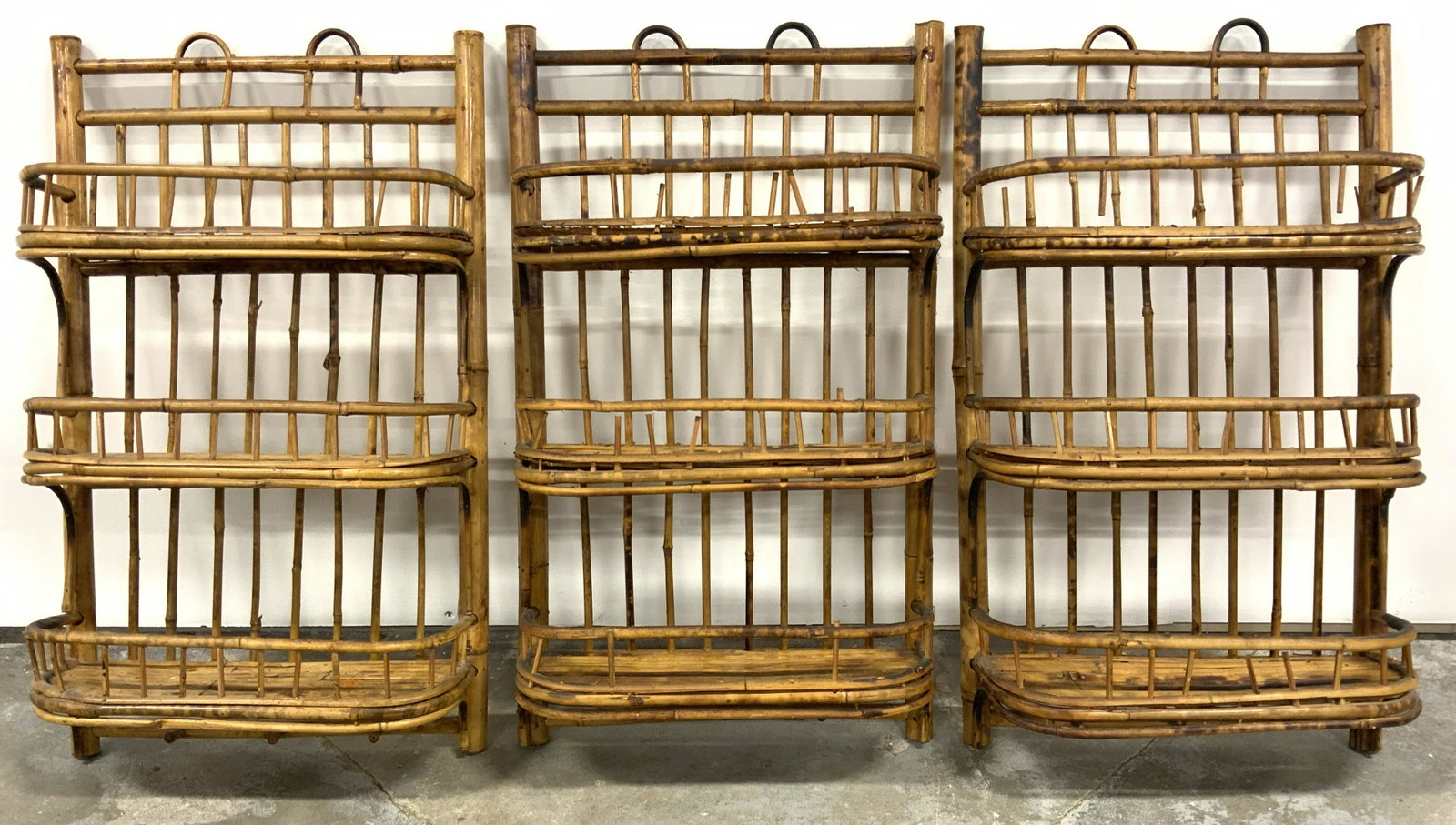 Set 3 Vintage Bamboo Wall Shelves: Wall shelves are vintage. Each piece appears to be bamboo. Each contains 3 shelves with gallery. Each measure approx 25 inches tall 15 inches wide 5 inches deep. Wall shelves, bamboo shelves, hanging 