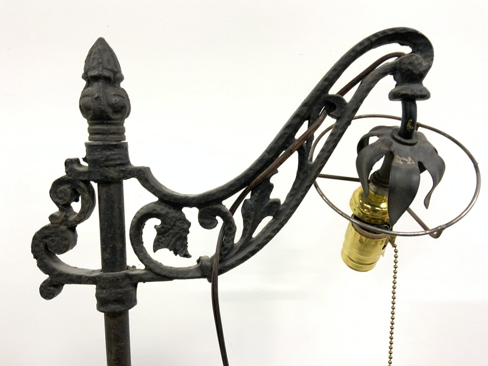 Antique Metal Floor Lamp W Leaf Feet: Floor lamp is vintage possibly antique. Piece is black toned & metal, possibly iron. Lamp has tripod style legs with leaf structures at ends. Top of piece has c scroll & leaf detail. Piece measures ap