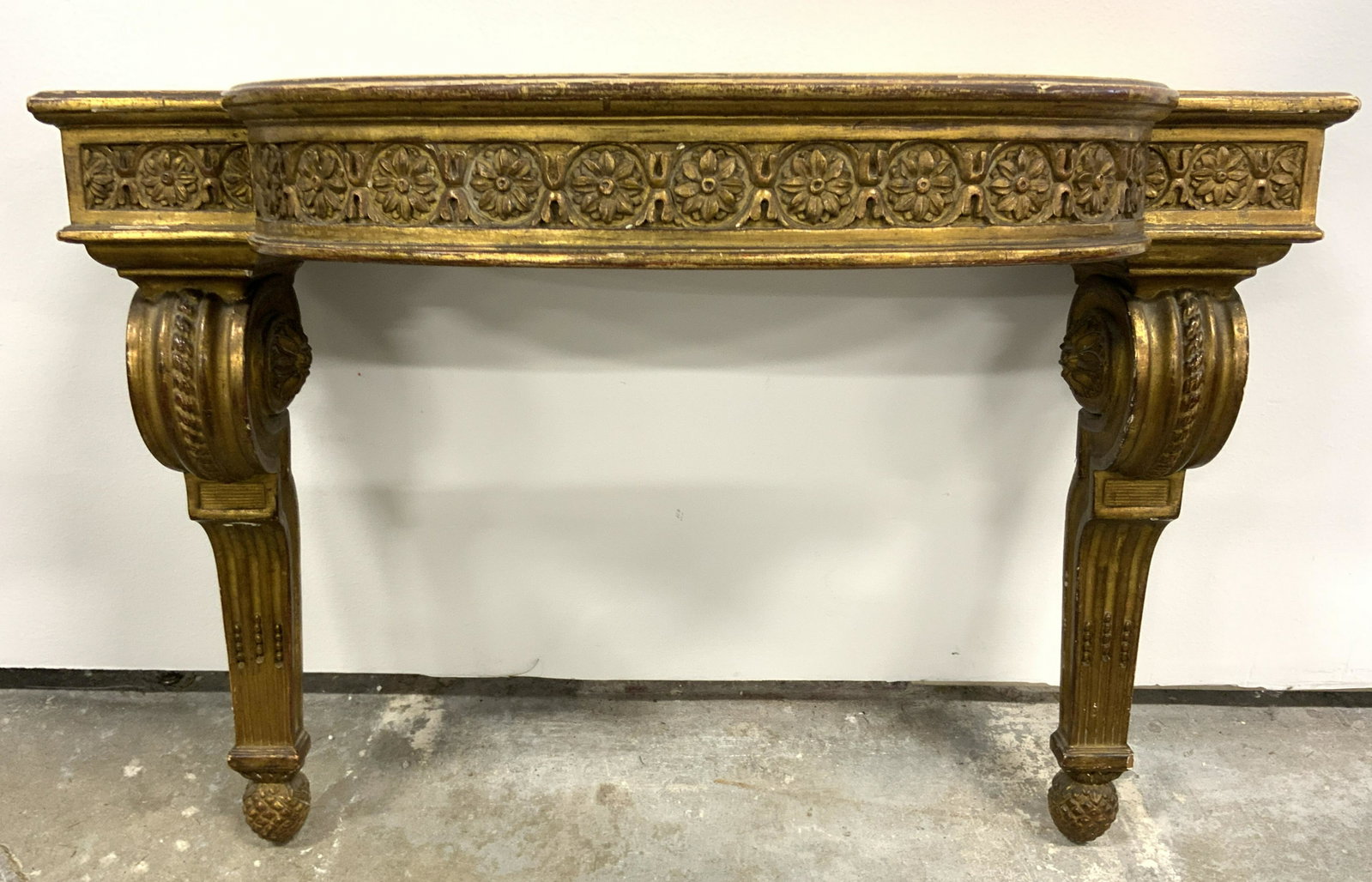 Carved Gold Leafed Wooden Wall Shelf: Wall Shelf appears to be antique. Piece is wooden with layer of gold leaf. Shelf has intricately carved ornate detail. Piece also has intricate floral detail. Piece measures approx 16 inches tall 21 i