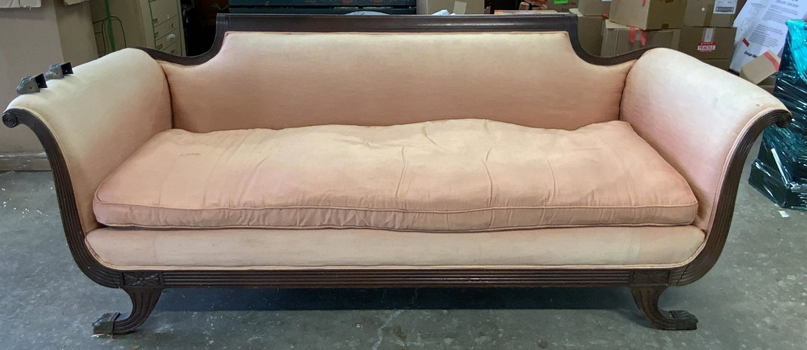Antique CURTIS FURNITURE CO INC Upholstered Sofa: Antique upholstered sofa. Label under cushion reads as CURTIS FURNITURE CO INC MAKERS OF FINE UPHOLSTERED FURNITURE NEW YORK CITY. Sofa arms are scrolled, each leg is capped with a brass lions paw, tw