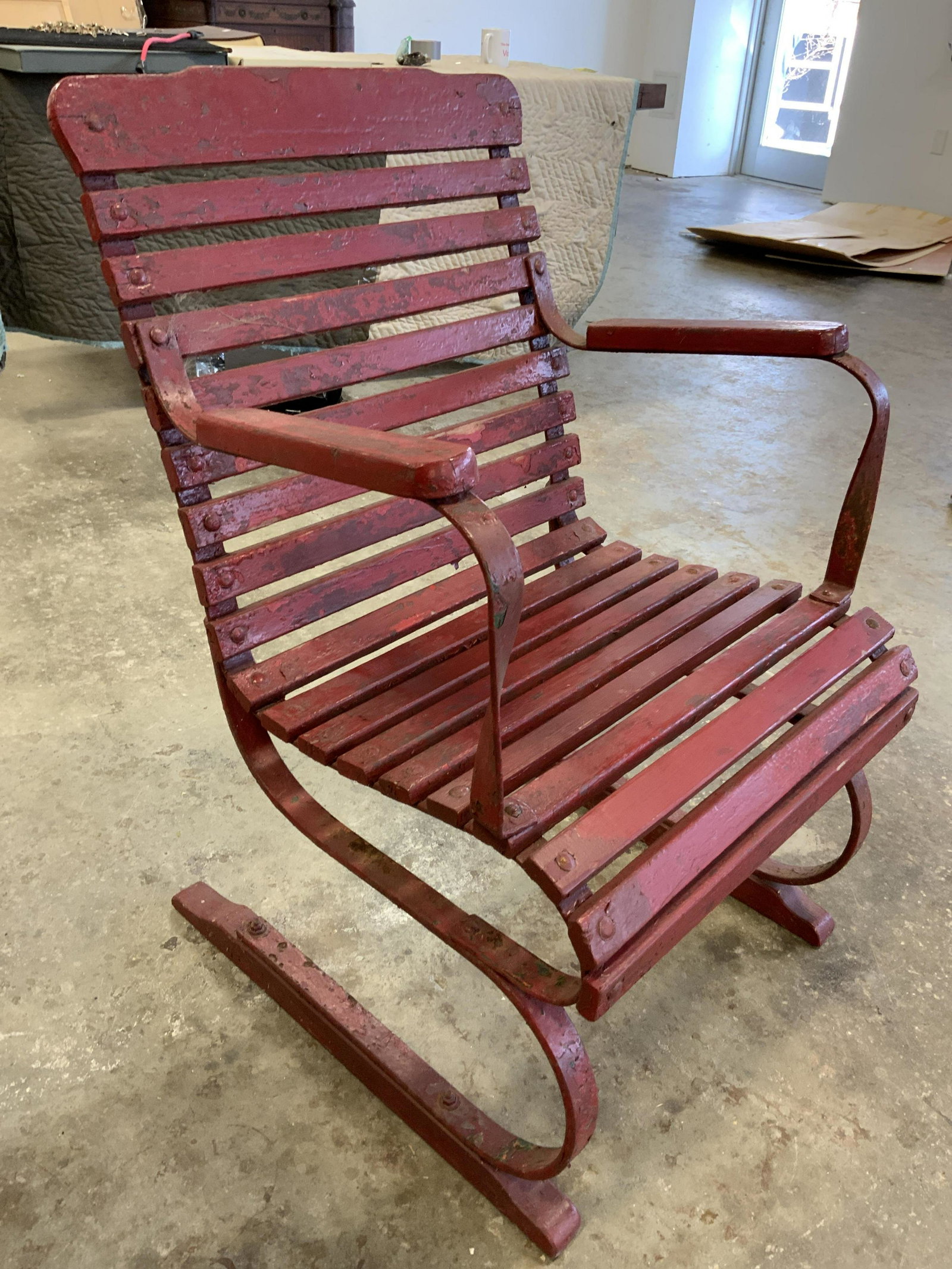 Antique Wood & Metal Rocking Chair: Antique wood and metal chair. Wood slats mounted to a metal frame. Feet are wooden. Bench is painted in crimson tones. Measures approx 33.25 inches H, 21.75 inches W, and 23 inches deep. Wear is consi