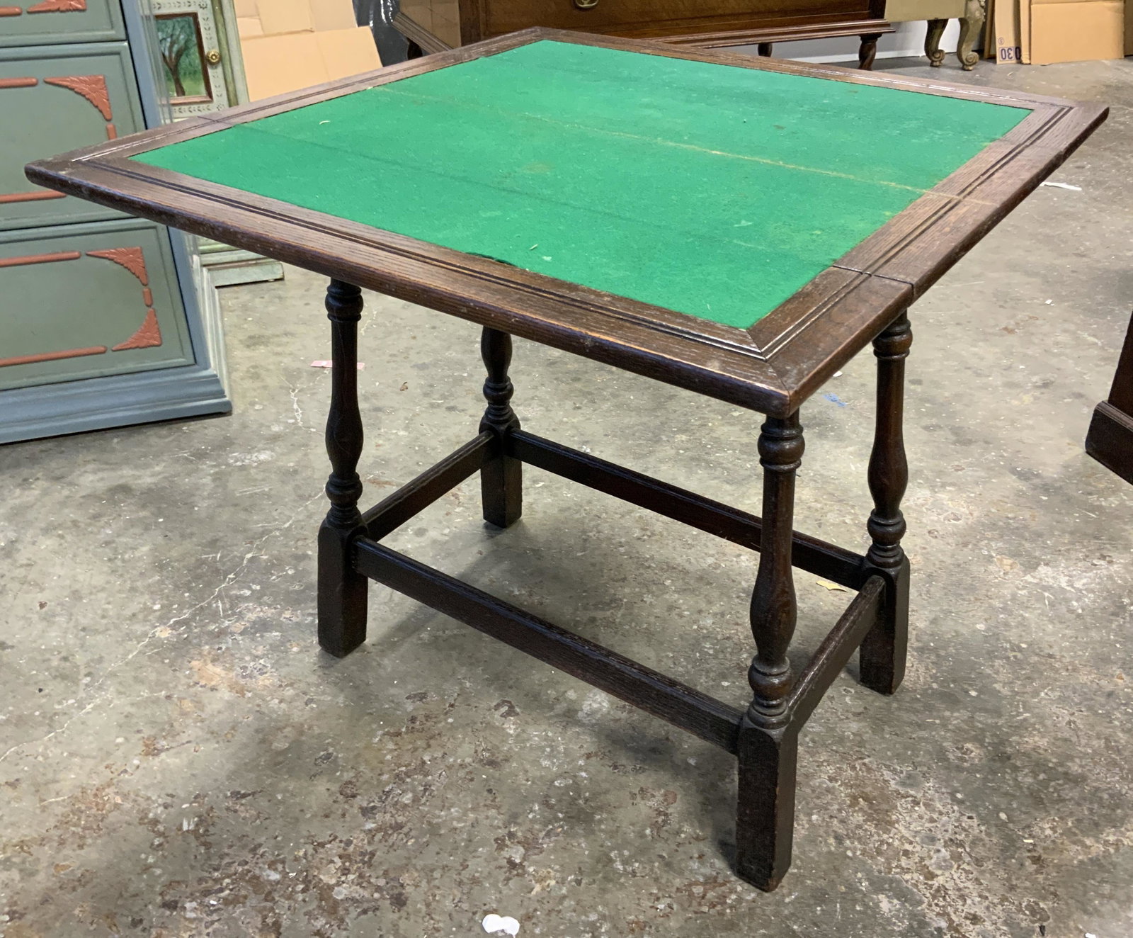 Vintage Collapsible Wooden Game Table: Vintage wooden game table. Leaves fold inward and on top of tabletop, tabletop is lined with fabric. Fabric needs cleaning. Measures approx 27.25 inches H, 30 inches W, and 30 inches deep. Parts of th