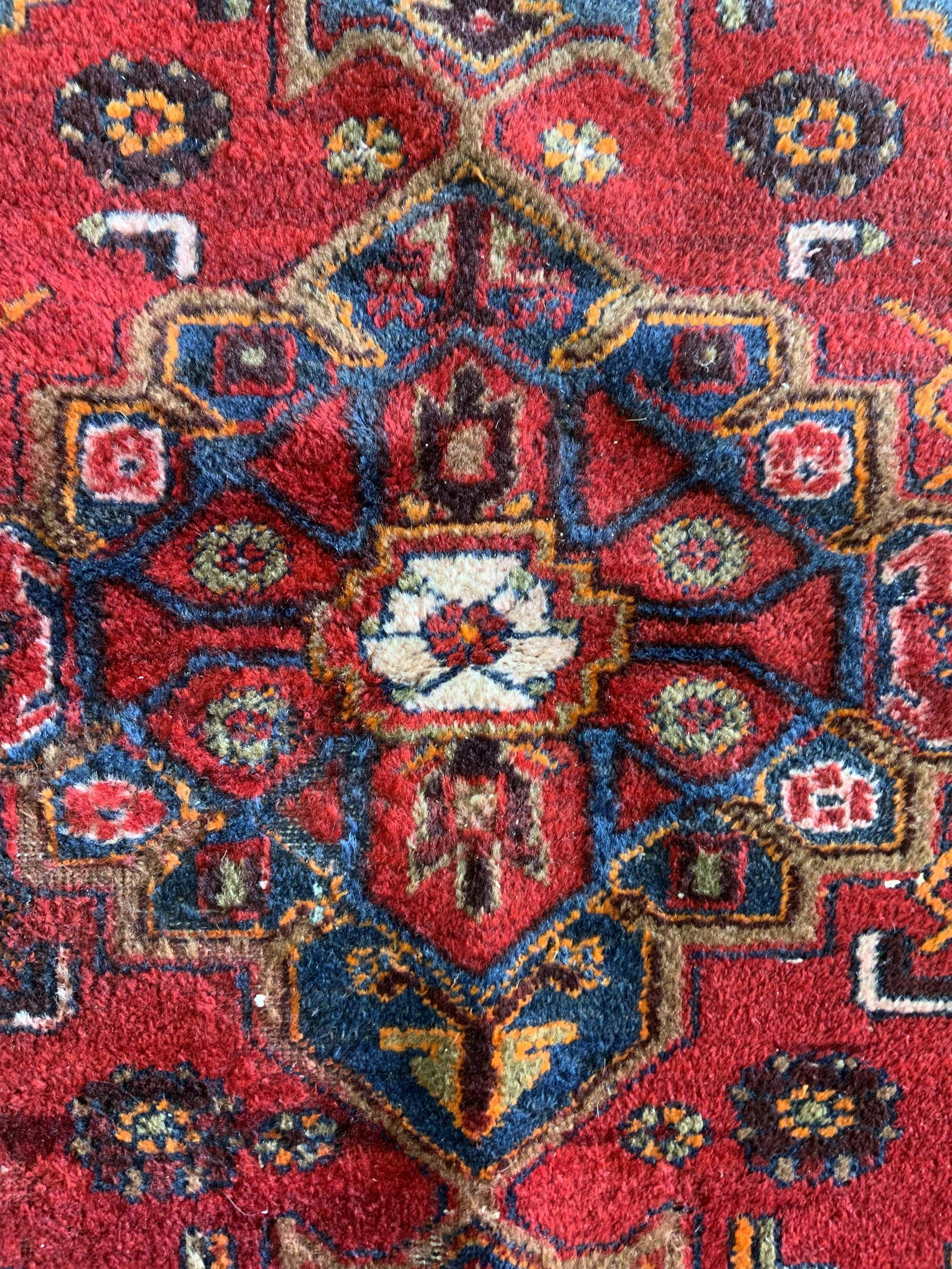 Vintage Fringed Wool Area Rug: Vintage wool rug, one end is fringed, fringes on one end are absent. Decorated by a multi toned pattern. Measures approx 81.5 inches long, and 52 inches W. Wear is consistent with age and use. Require