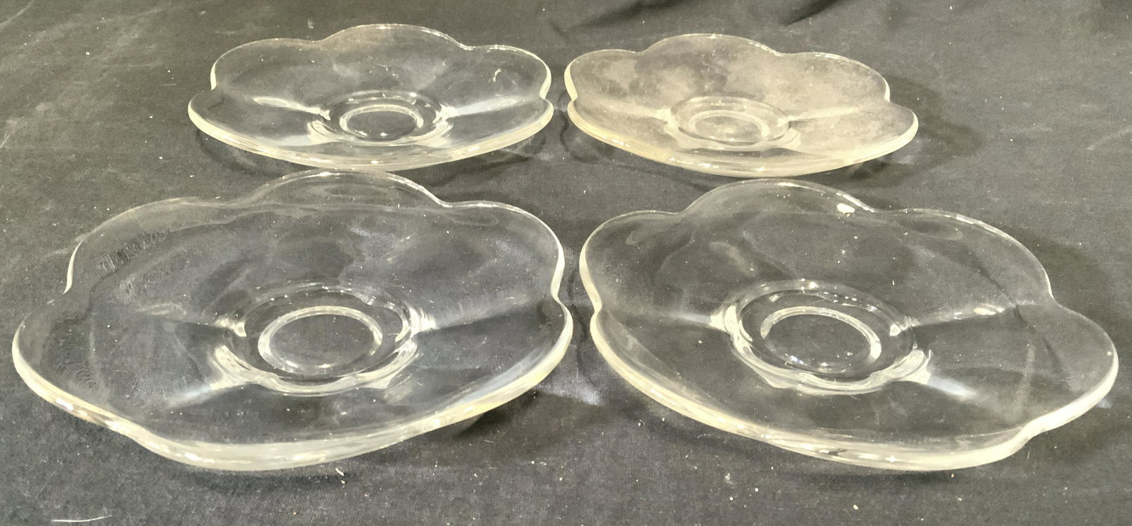Set 4 Floral Shaped Glass Dishes: Lot includes 4 dishes. Each are glass and have shapes resembling flowers. Each piece measures approx 6 inches wide. Glass dishes, floral dishes, dish ware, glass dish ware, tableware. 6 Property of Ja