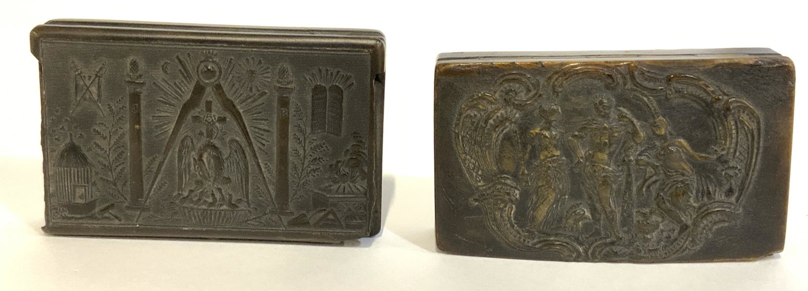 Lot 2 Carved Mix Media Pill Boxes: Lot includes two carved mix media boxes, possibly shell, possibly antique. Lids of each depicts different art work, one depicting biblical imagery, the other two female figures flanking a male figure 