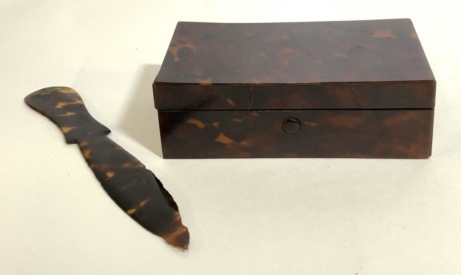 Lot 2 Vintage Shell Accessories: Lot includes two vintage, possibly antique shell accessories. Includes a letter opener/cutting tool, and a trinket box. The trinket box is lidded, the hinge is spring loaded. The box interior is lined