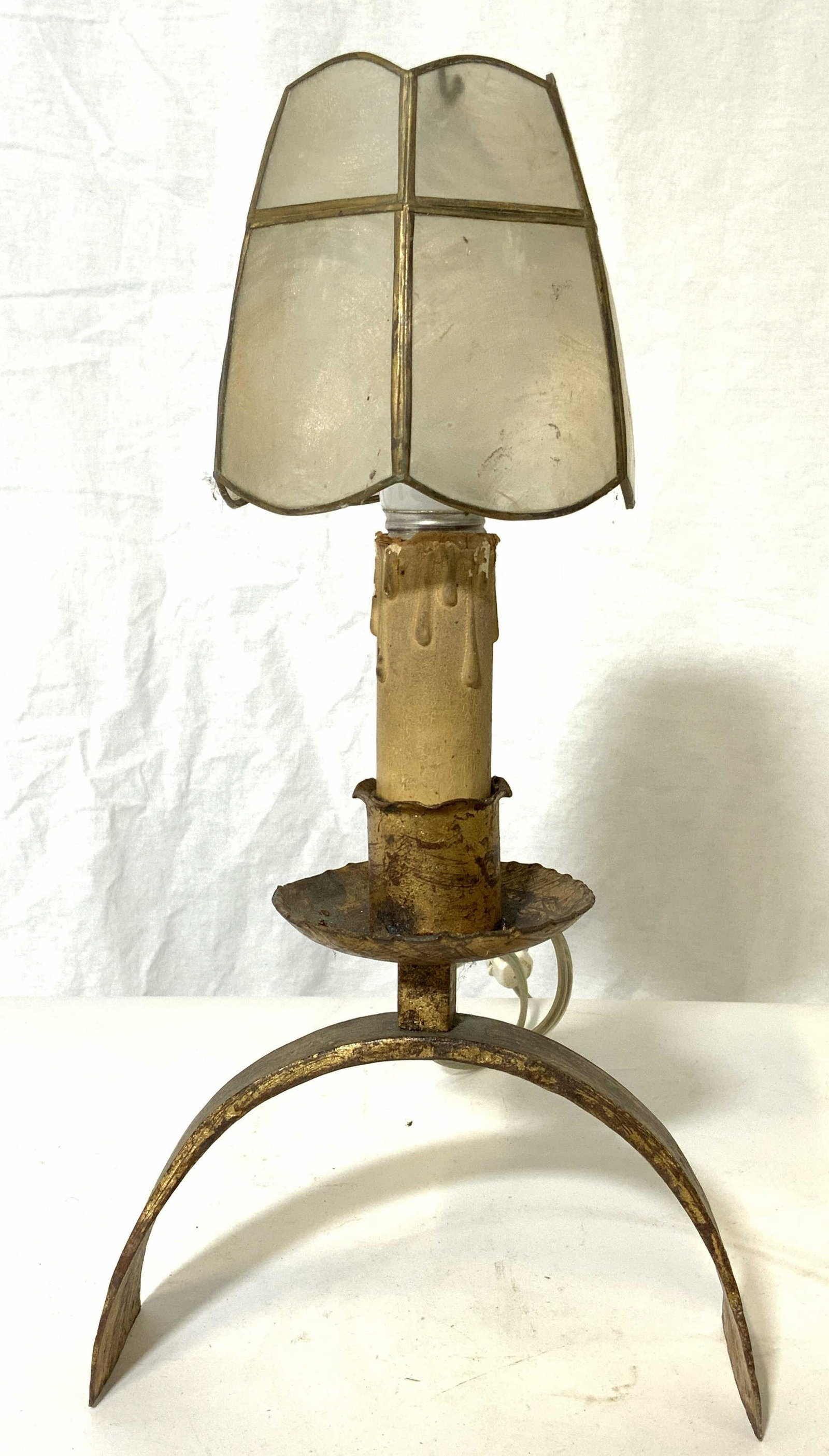 Antique Gilded Metal Candlestick Lamp W Shade: Lamp is antique. Piece is gilded metal, possibly iron. Piece has candlestick style. Base of lamp has arch shape. Piece measures approx 13 inches tall 7 inches wide 3 inches deep. Lamp, antique lamp, g