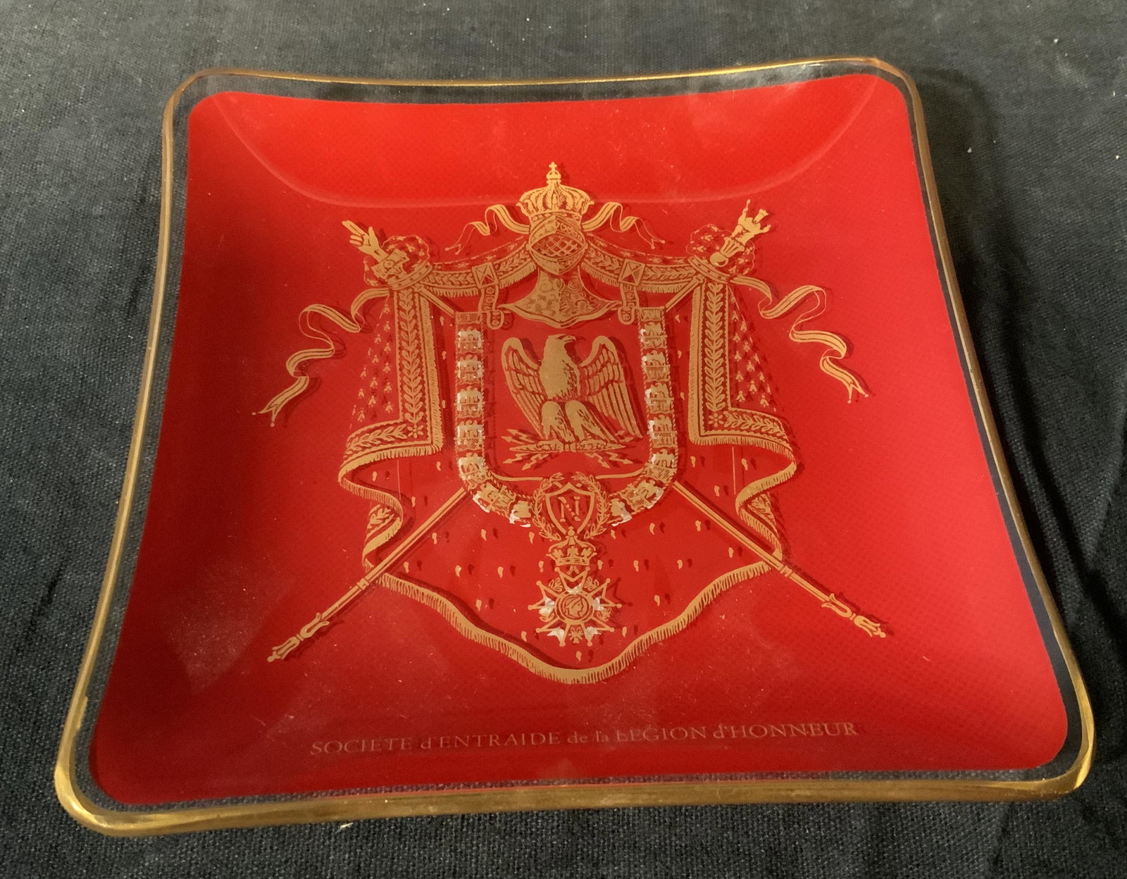 Societe d'Entraide de la Legion d'Honneur Dish: Societe societe d'entraide de la legion d'honneur dish, dish is made of a clear glass with a print atop it with a crest and the words ‘ societe d'entraide de la legion d'honneur’, edges of dish ar
