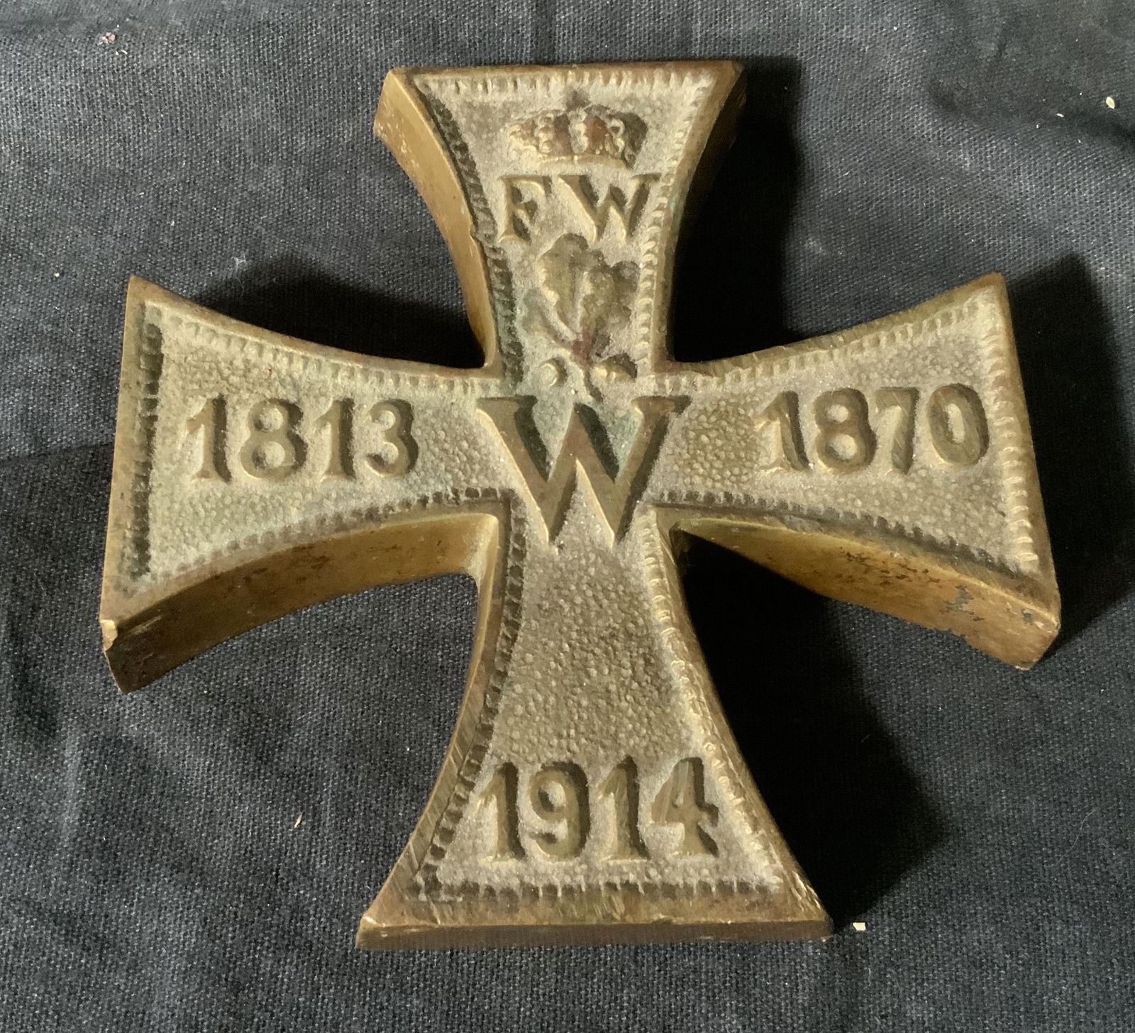 Brass Cross Paper Weight: Brass Cross Paper Weight, text to cross reads ‘FW 1813 W 1870 1914’, in the shape of an equilateral cross, piece measures approximately 4 by 4 inches, some scuffs to piece overall in good conditio