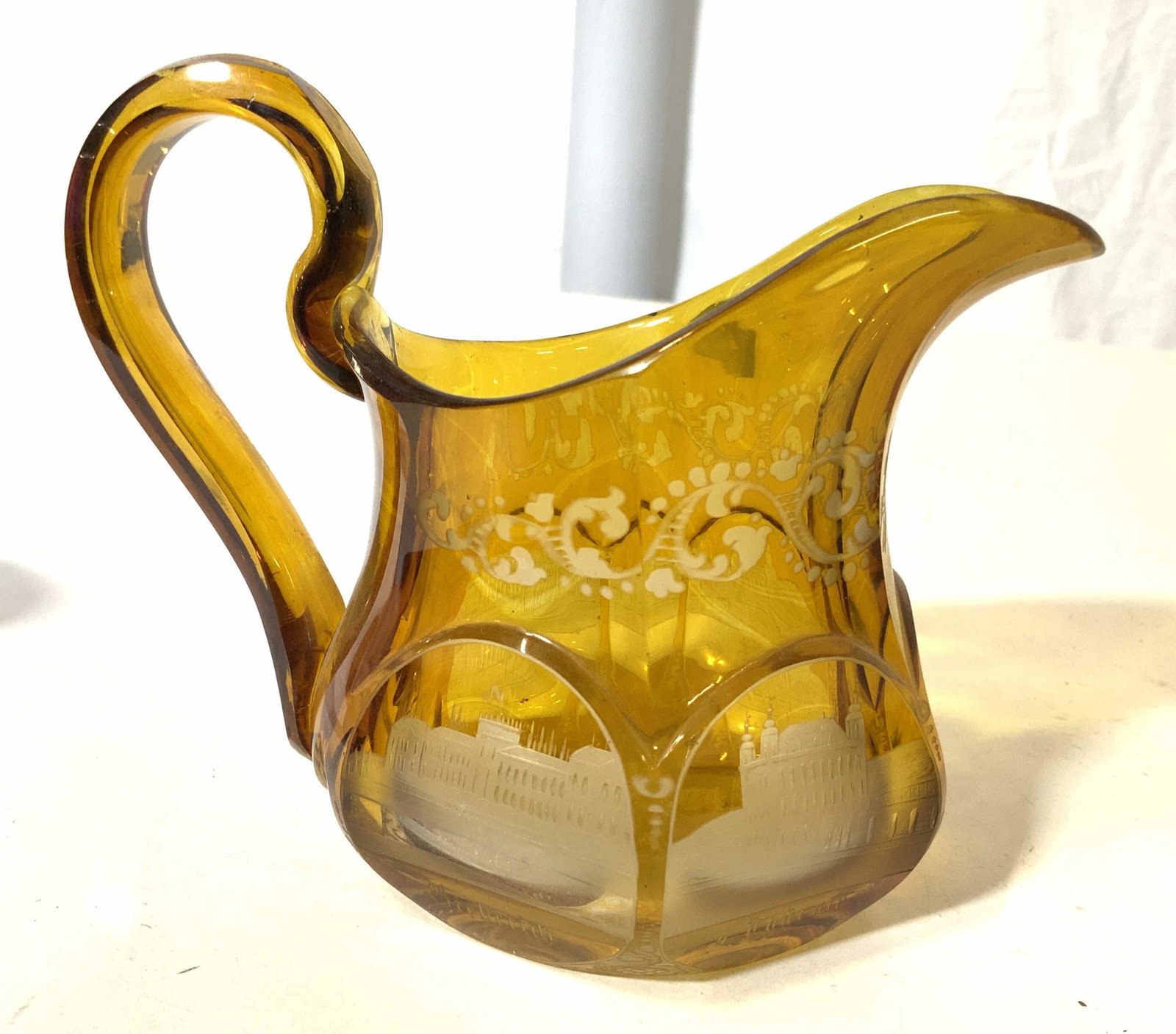 Lot 5 Tableware, Tabletop Accessories: Lot includes 1 amber toned art glass pitcher, 1 petite blue art glass vase, 1 Richard GINORI porcelain saucer, & 1 SPODE porcelain dinner plate. Spode plate measures approx 10 inches wide. Tabletop, t