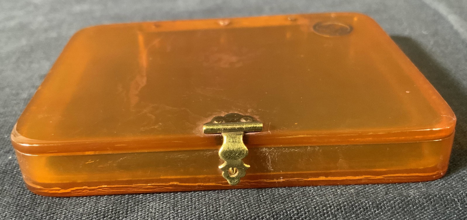 Vintage J & H Bakelite Cigarette Case: Vintage J & H Bakelite Cigarette Case, inscription reads ‘J & H’, measures 3 1/8 x 2 3/8 inches, some surface wear but overall in good condition, comes in red case, Property of Janine Metz estate,