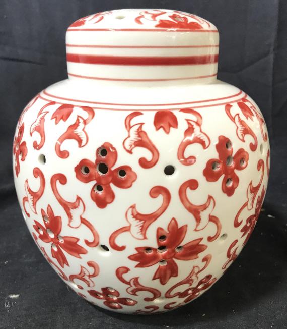 Porcelain Ginger Jar W Pierced Detail: Piece is possibly a music box. Piece has battery area on underside. Piece is white toned with red toned floral detail. Piece has pierced detail. Measures approximately 8 inches tall 6.5 inches wide. P