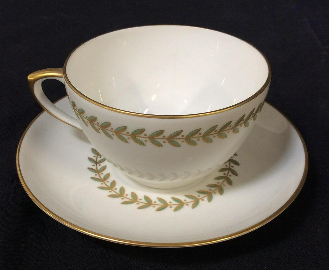 VISTA ALEGRE VA Portugal Tea Cup And Saucer: Vista Alegre VA Portugal Tea Cup And Saucer. VA Portugal insignia stamped on underside of both cup and saucer. Cup and saucer both feature a vine design with green leaves and a Gilt accent. Cup measur
