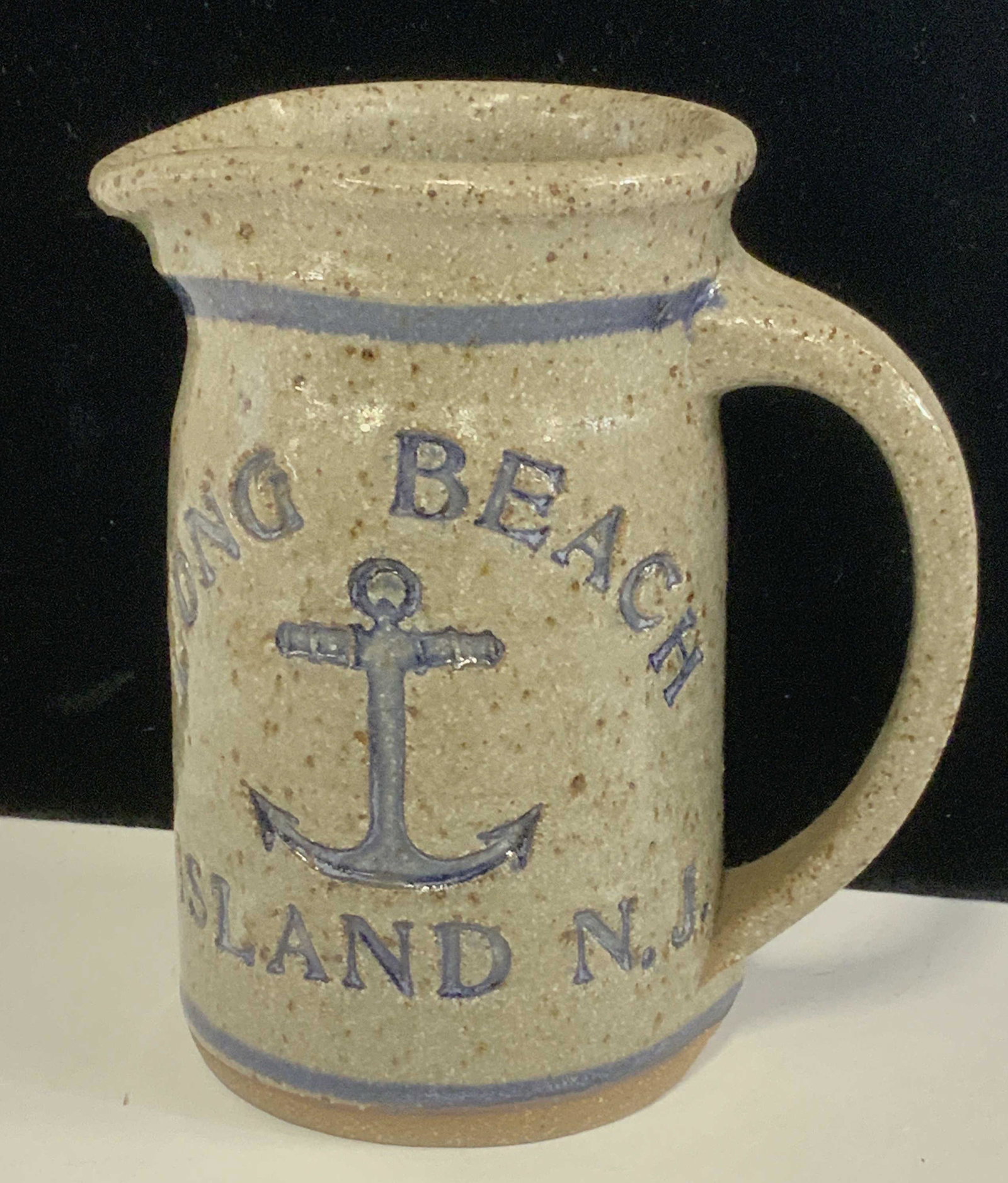 Long Beach Island Salt Glaze Jug w/ Anchor: Salt Glazed Stoneware Vessel that reads Long Beach Island, N.J. With center Ship Anchor. 6 in tall. 5.5 in wide. Tall mug, Salt glazed jug, stoneware, Desktop vessel, kitchenware, pen holder, accessor