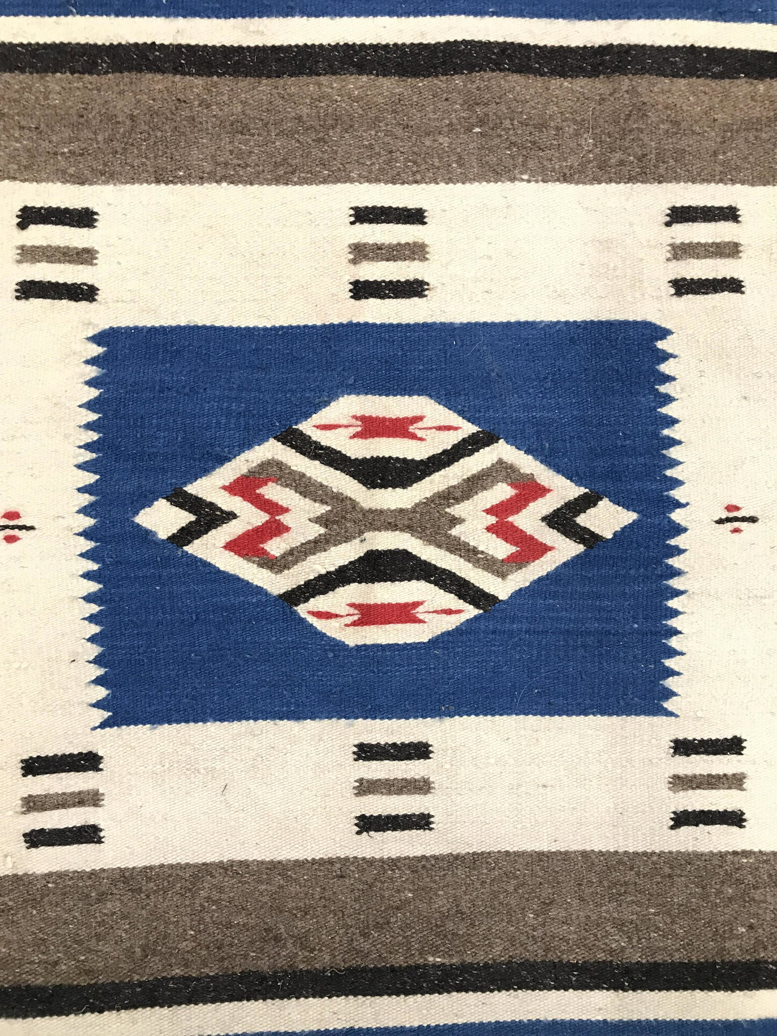 Handmade Native American Style Vintage Wool Rug: Rug is wool and handmade. Piece is vintage possibly antique. Rug contains multi toned geometric and stripe detail. Piece measures approximately 46 inches long 20 inches wide. Rug, carpet, area rug, wo