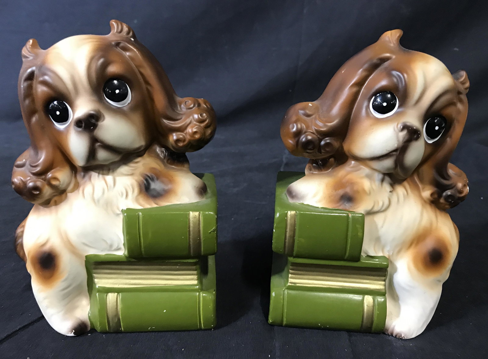 Vintage Cocker Spaniel Bookends: Pair of vintage cocker spaniel book ends. Underside label reads as MADE IN JAPAN and are numbered 3416. Bookends are hand painted and crafted from ceramic, depicts cocker spaniels perched on stacks of