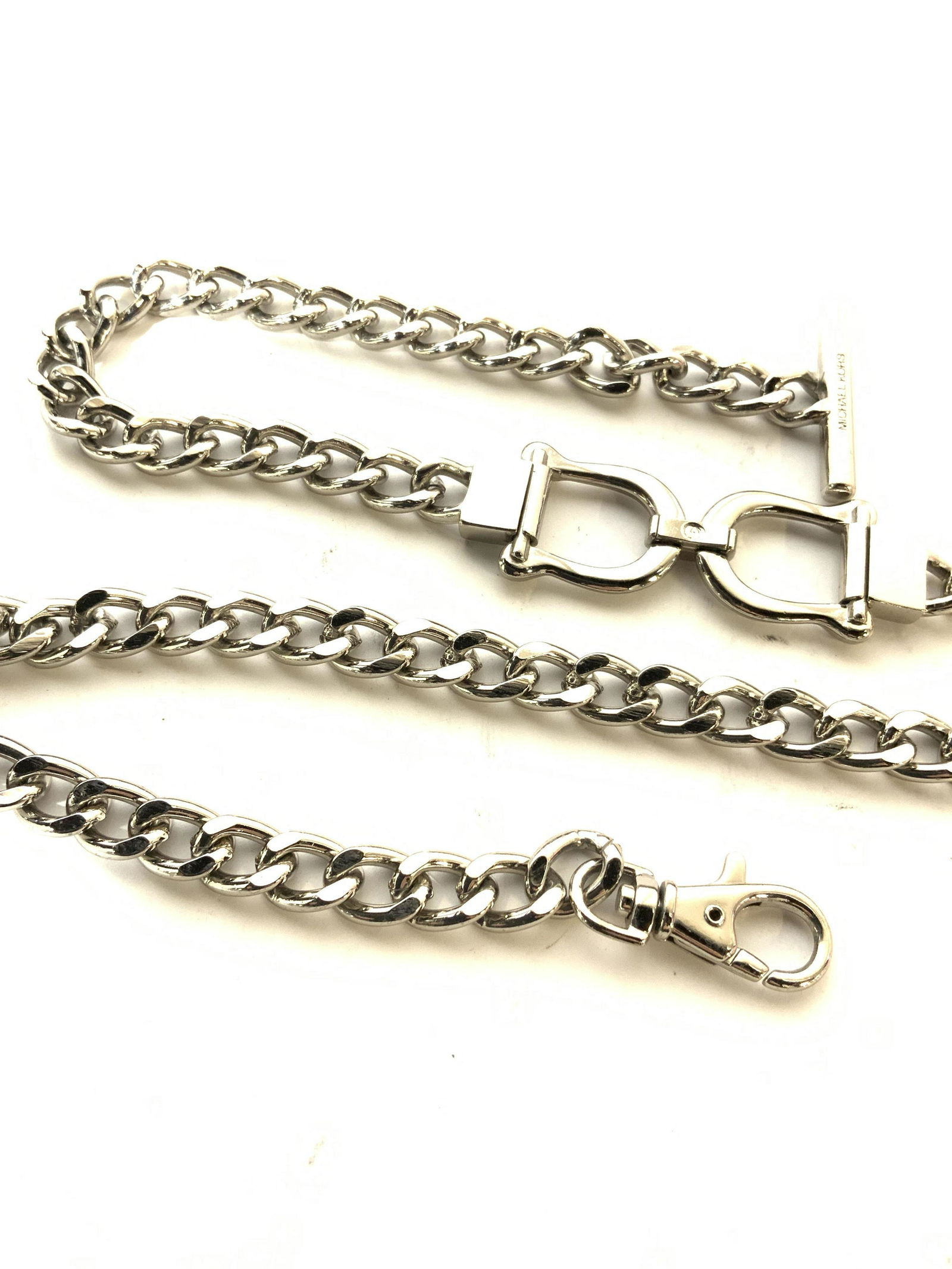 MICHAEL KORS Signed Chain Belt Accessory: Silver Toned And weighted piece by Luxury American designer Michael KORS, signed on on metal bar and between horse shoe . Can be worn as a necklace if desired, or as a belt. One end has a large thumb