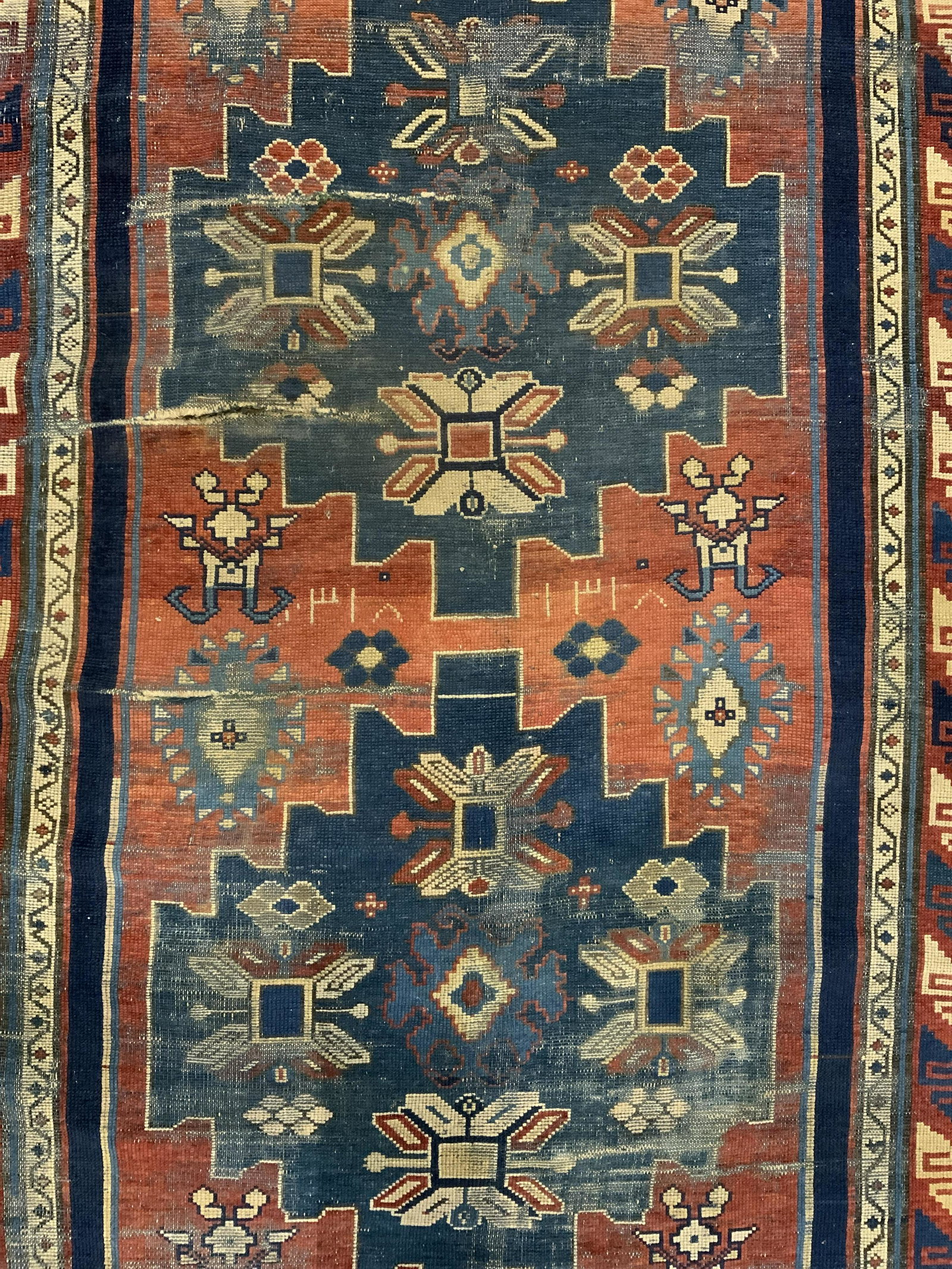 Antique Handmade Middle Eastern Wool Rug: Rug is handmade and wool. Piece is antique. Rug contains multi toned geometric detail. Piece measures approx 119 inches long 51 inches wide. Rug, carpet, area rug, wool rug, handmade rug, antique rug.