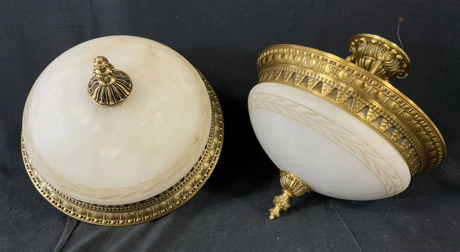 Pair Gilded Metal & Glass Light Fixture: Pair of gilded metal light fixture. Glass is frosted , etched Laurel like detailing present, finial decorated with cast detailing. Each measures approx 15 inches H, and 14 inches in diameter. Wear is 