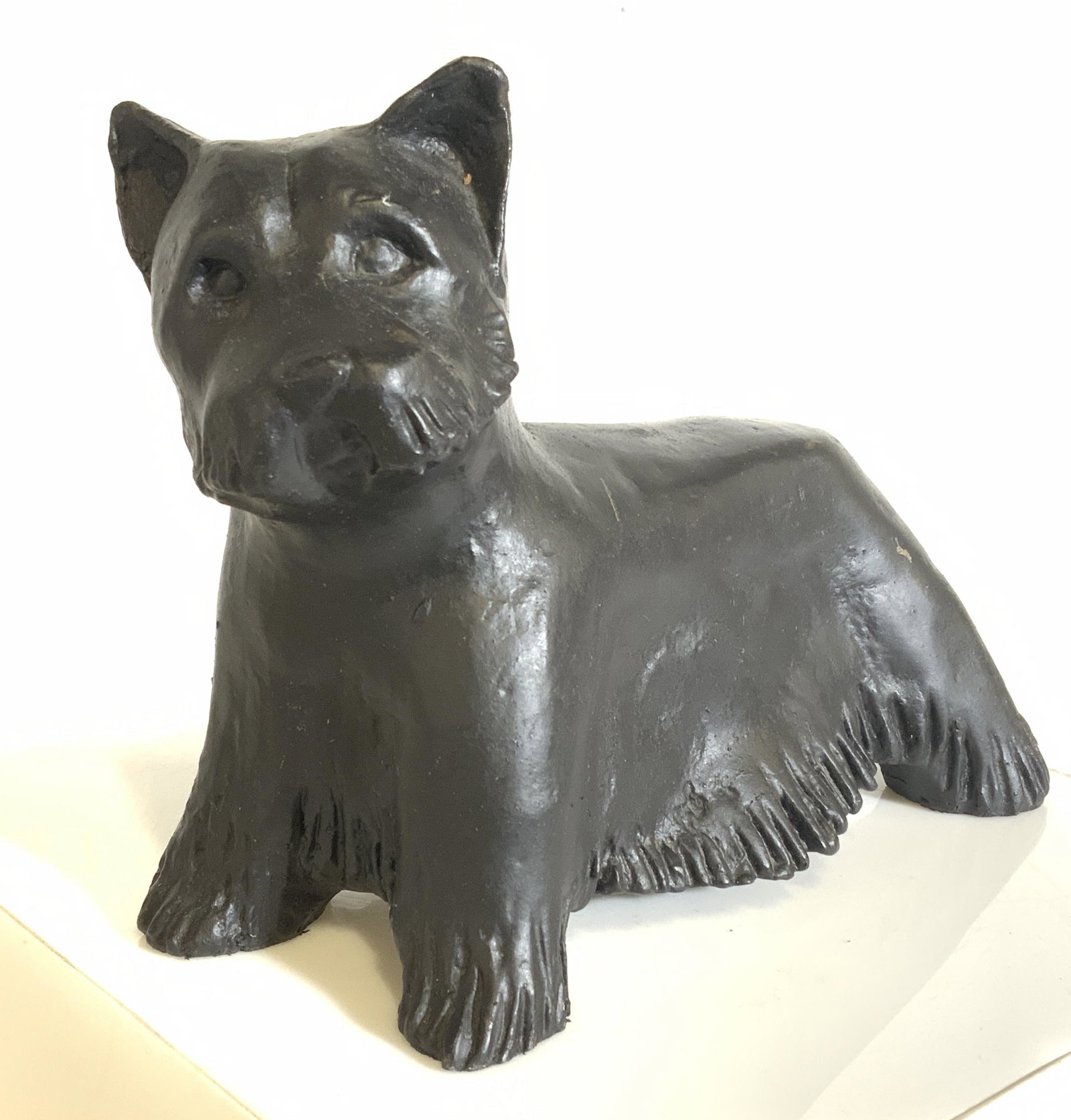 Vintage Cast Iron Terrier Sculpture: Cast iron Scottish terrier sculpture. Sculpture has been painted black, some light chipping of the paint is present. The underside of each foot is lined with fabric. Measures approx 5.5 inches H, and 