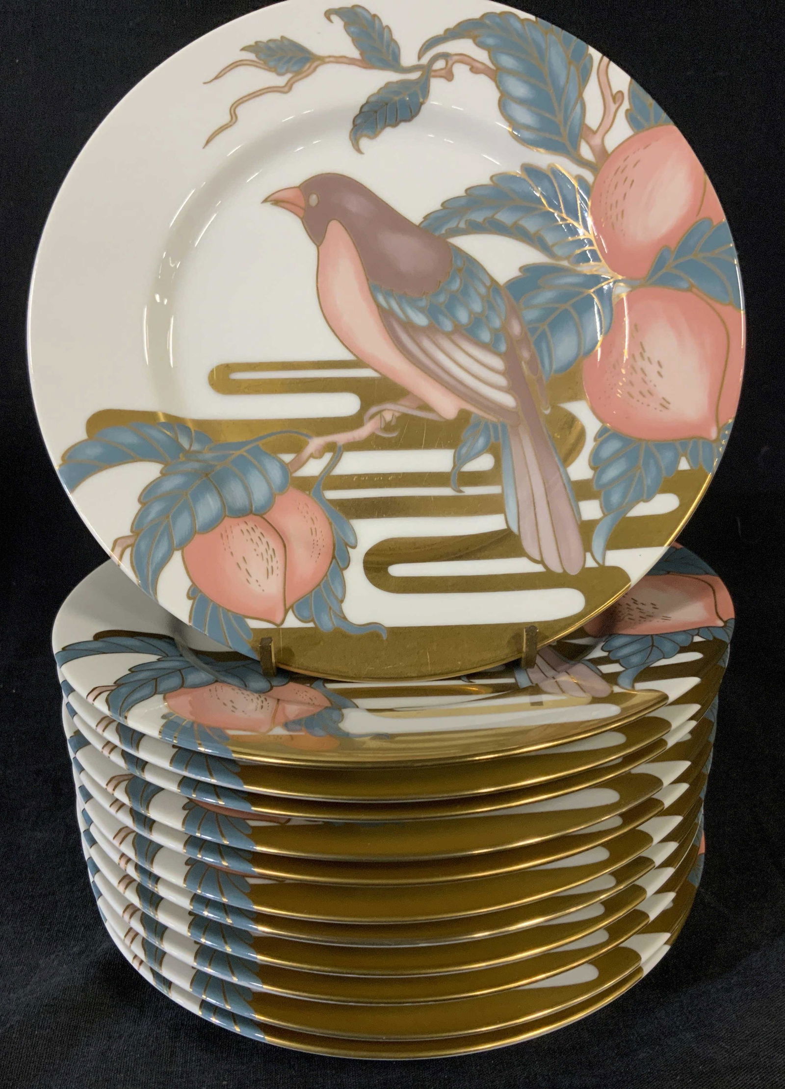 Set 12 FITZ & FLOYD NIGHTINGALE Plates: Set of twelve nightingale plates. Plates depict a nightingale perched in a peach tree, colored in multiple tones, gilt paint swirl pattern decorated back and foregrounds. Measures approx 7.5 inches in