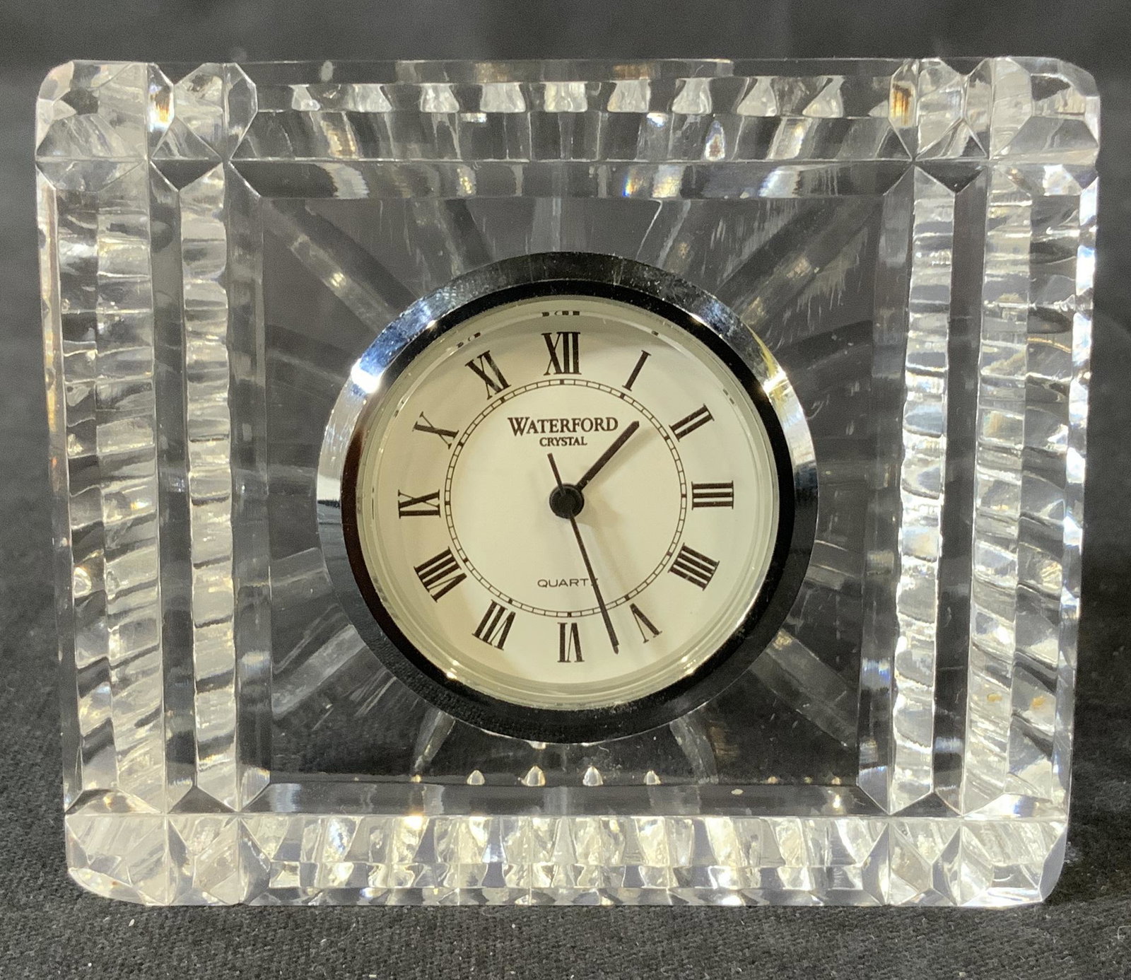 Waterford Crystal Desk Clock: Waterford Crystal clock, inscription to piece reads ‘Waterford Crystal quartz’, features Roman numerals, measures 2 1/2 inches tall x 2 7/8 inches at widest point, some scratches to piece but over