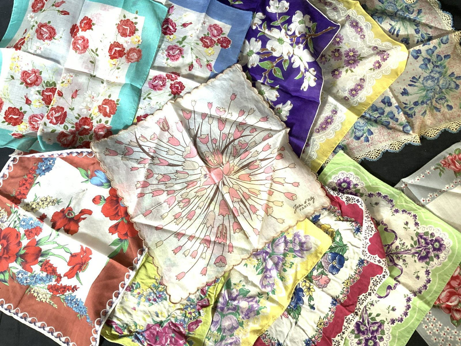 12 Collectible Vntg French Country Floral Hankies: Floral hankies , mostly cotton, all rich in color, different types of flowers, French Country- Victorian Style, one pink tulip hankie signed JEOU d’ Orly Paris. One has wear, can up cycle. Manyin go