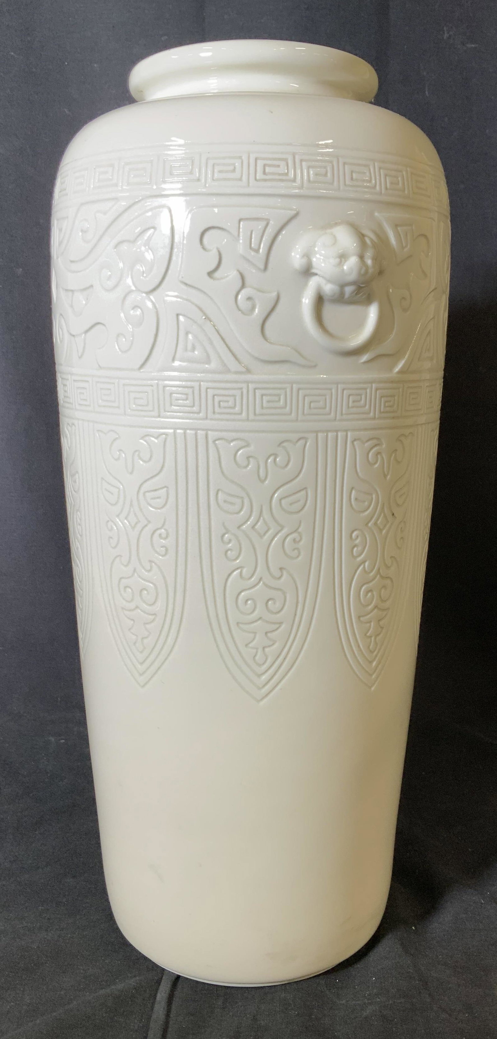 Chinese Vase, Foo Dog Handle Motif: Classic Chinese decorative patterns of Greek key Cloud & Thunder, Chinese Taotie and Dragon Face. Vase Flanks by Foo Dog Door Knocker Rings in Relief. Creamy of white. 14 in. Ht. Chinese Vase, Asian D