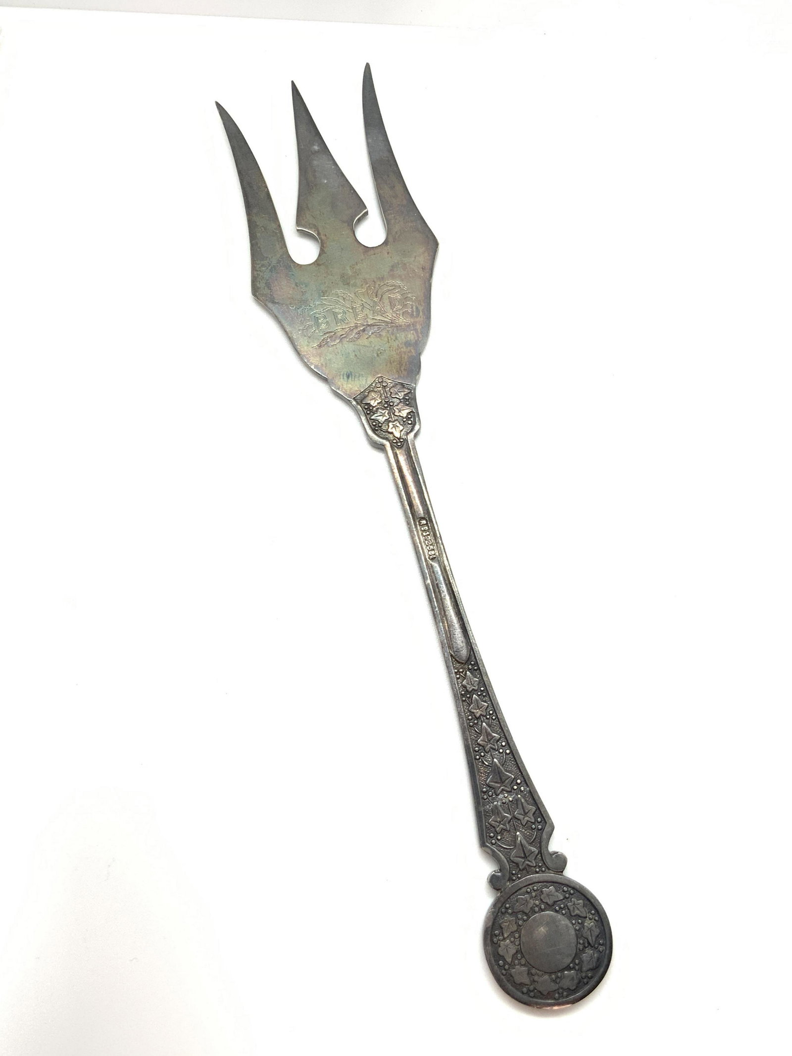 Vintage STERLING SILVER Specialty Bread Fork: A sterling silver specialty bread fork. Vintage, possibly antique circa early 1900s. The fork features etched nature motifs and leaves throughout the design. The topside is etched: BREAD. The handle r