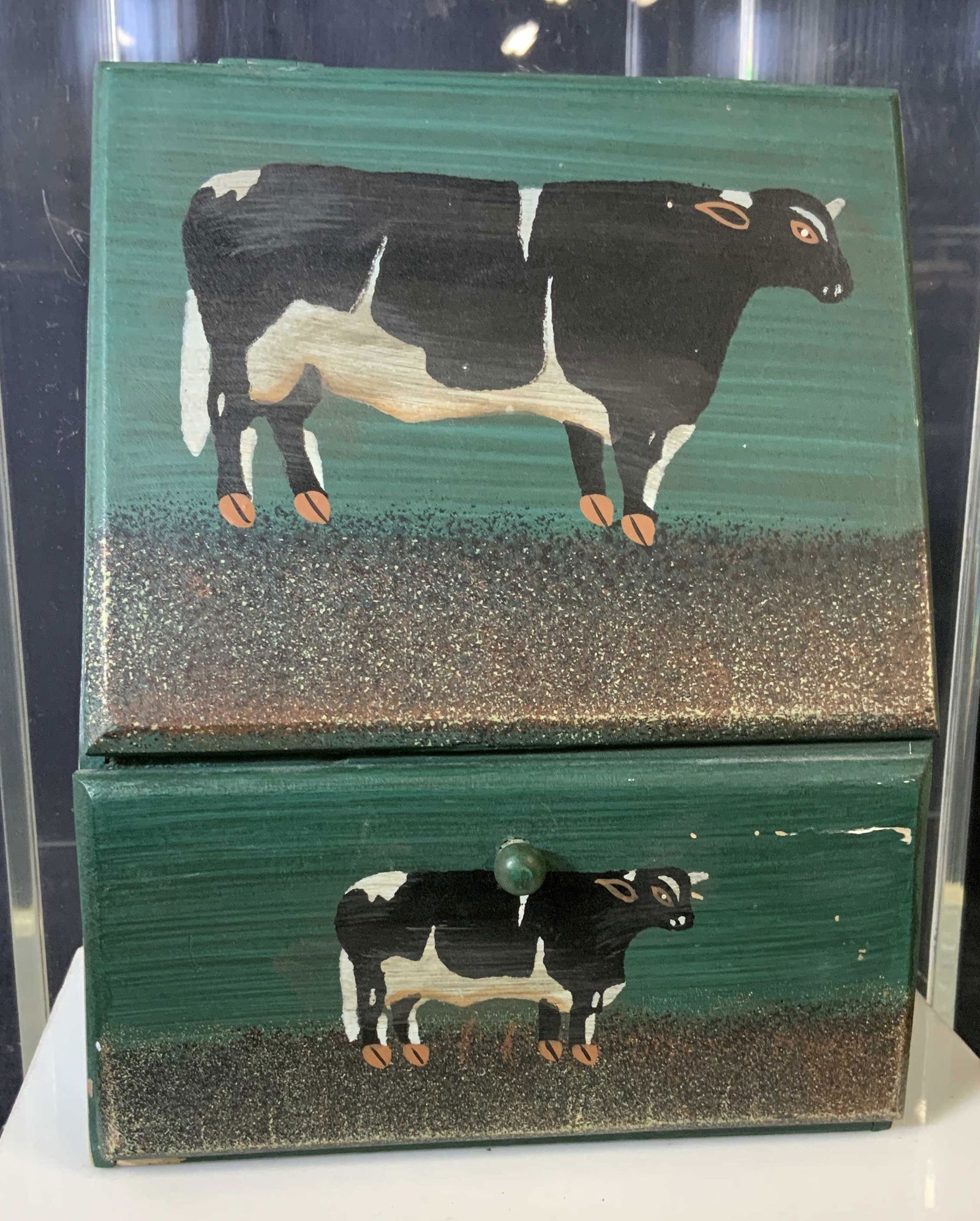 Folk Art Cow Wooden Desktop Accessory: Hand Painted Miniadure Tabletop Accessory, painted with cows. Pull out drawer and hinged top open compartment. Use as mail center, jewelry box, keepsake box, Key box, more. 7.5 in. Ht, 4.5 in. W. Coun
