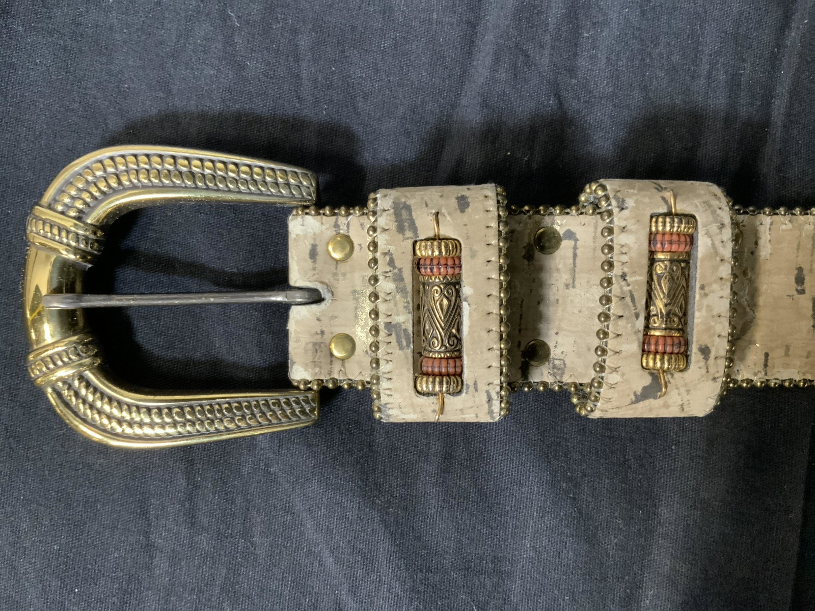 Leather and Suede Belt: Leather and Suede Belt, inscriptions read ‘2282 Made in USA M’, tooled metal buckle, measures 40 inches long, buckle measures 2 5/8 x 2 1/2 inches, some wear from usage and loss of gold toned laye