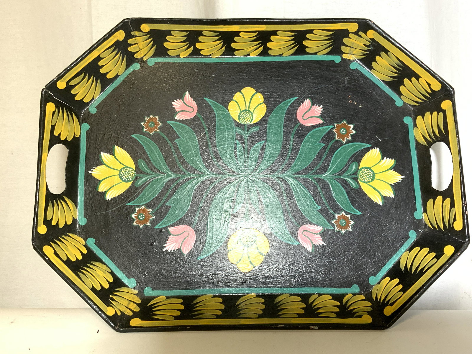 Antique Hand Painted Toleware Tabletop Tray: Underside of tray is marked HAND PAINTED THAILAND. Tray is hand painted with multi toned floral & leaf detail. Piece measures approx 20 inches long 15 inches deep. Each side of tray has handle. Tray, 