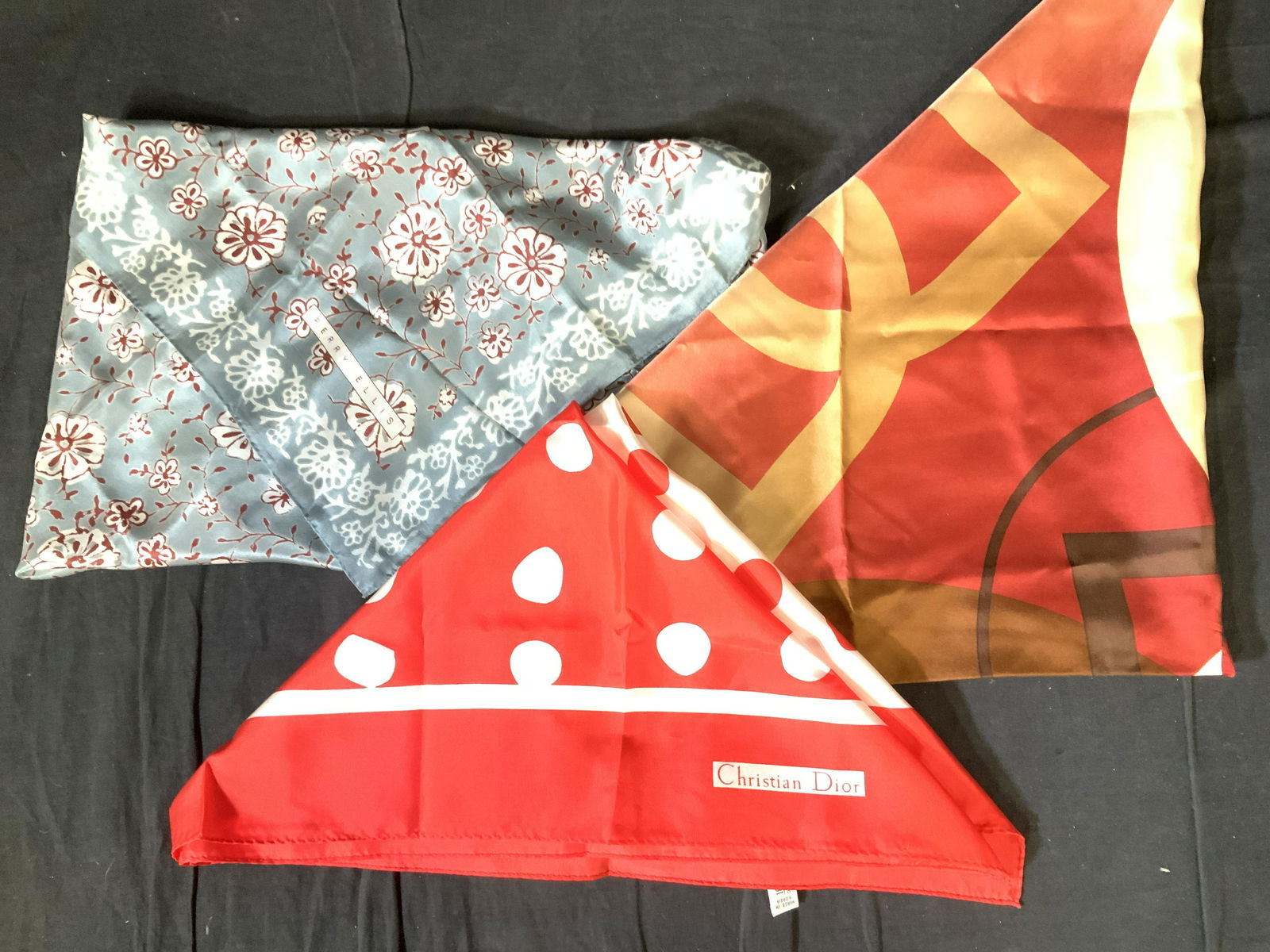 Lot 3 DIOR, PERRY ELLIS, TANNER Silk Scarves: Silk ladies scarves, all signed and /or with designer label attached. All Hand stitched. Christian Dior red & White large polka dot. 34.5 in. Perry Ellis Grey and Burgundy floral, 31 in. Tanner multi