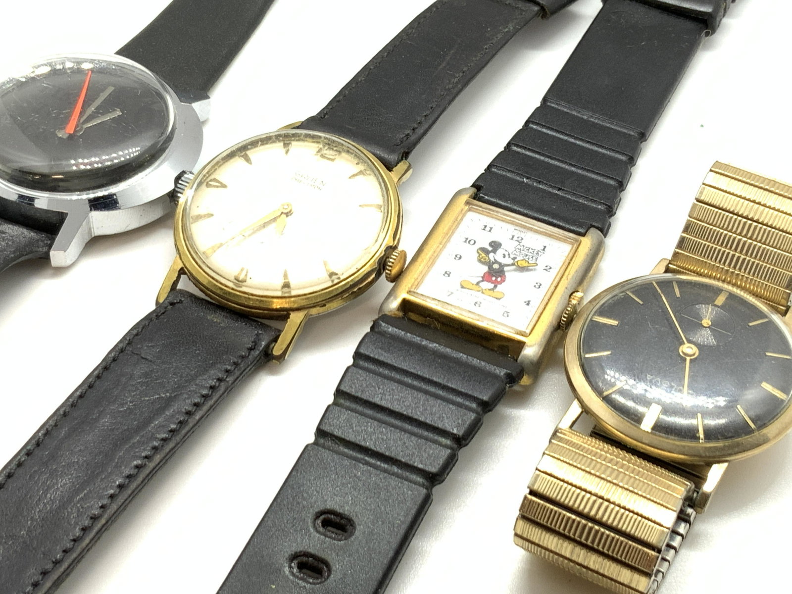 Lot 22 BULOVA & More Watch & Watch Accessories: Four watches with eighteen watch accessory pieces. Watches include one plated gold metal watch signed BULOVA on watch face and underside. Underside also signed 10k Rolled Gold Plate. Watch is stretchy